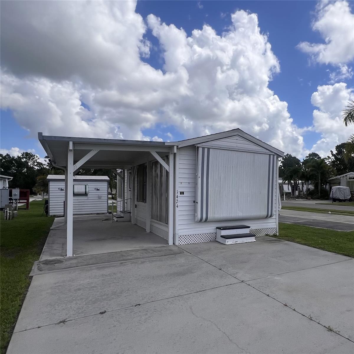 Welcome to this move in ready 1990 manufactured park model with 396' of efficient, comfortable living in the desirable 55+ community of Alligator Park in Punta Gorda. Thoughtfully maintained this fully furnished 1 bedroom, 1 bathroom residence is the best-priced home in the community—and the price includes the park share valued at $60,000!
Recent updates include a new shingle roof (2022), heavy-duty double-insulated carport with sturdy 4x4 posts, two energy-efficient mini split A/C units (2023) to help keep electric bills low. The inviting bedroom features a queen-size bed, built-in closet, with dresser drawers, while the cozy living room offers a sofa with a queen-size air mattress—perfect for overnight guests. You’ll also enjoy two smart TVs for streaming entertainment.
The updated bathroom boasts a new walk-in shower and comfort-height toilet (2023). The well-equipped kitchen features a quaint dining area, refrigerator/freezer (2022), microwave, two induction cooktops, countertop appliances, and plenty of storage. Durable laminate flooring runs throughout—no carpet—and the home has been smoke-free and pet-free!
Extras include hurricane shutters for all windows and doors, a double parking pad plus covered parking under the carport, an added bonus 8' x 10' shed with washer, dryer, sink, workshop space, and more storage.
Alligator Park offers a friendly, active 55+ lifestyle just minutes from downtown Punta Gorda, waterfront dining, shopping, and outdoor recreation. Don’t miss this opportunity to own a well-cared-for home in one of Punta Gorda’s most sought-after communities—turn key and ready for you to enjoy!