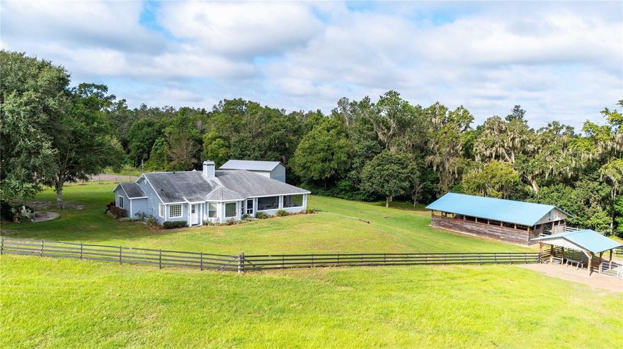 Welcome to your own slice of paradise nestled in the picturesque hills of Dade City. This stunning 15-acre equestrian property offers the perfect blend of peaceful seclusion and convenient accessibility. Minutes from I-75, this retreat feels worlds away while being only 10 minutes from downtown Dade City and 45 minutes to Tampa International Airport. This elevated property is high and dry with no flood risk, and it's surrounded by other large estate properties and wonderful neighbors. The home is a cozy 4-bedroom, 3.5-bath home featuring  over 2100+ sq ft of well-appointed living space. Natural light pours in through windows on every side, framing park-like views from every room. Equestrian enthusiasts will love the 4-stall barn complete with a tack room, feed room, wash rack and a covered area for parking your mower and tractor. The enormous lush pasture is cross fenced and ready for your horses to enjoy. A 1600+ sq ft detached garage adds additional storage or workspace flexibility. Whether you're relaxing on your porch, stargazing in the peaceful evenings, or taking your horses out for a ride, this property offers a lifestyle that’s becoming increasingly rare.