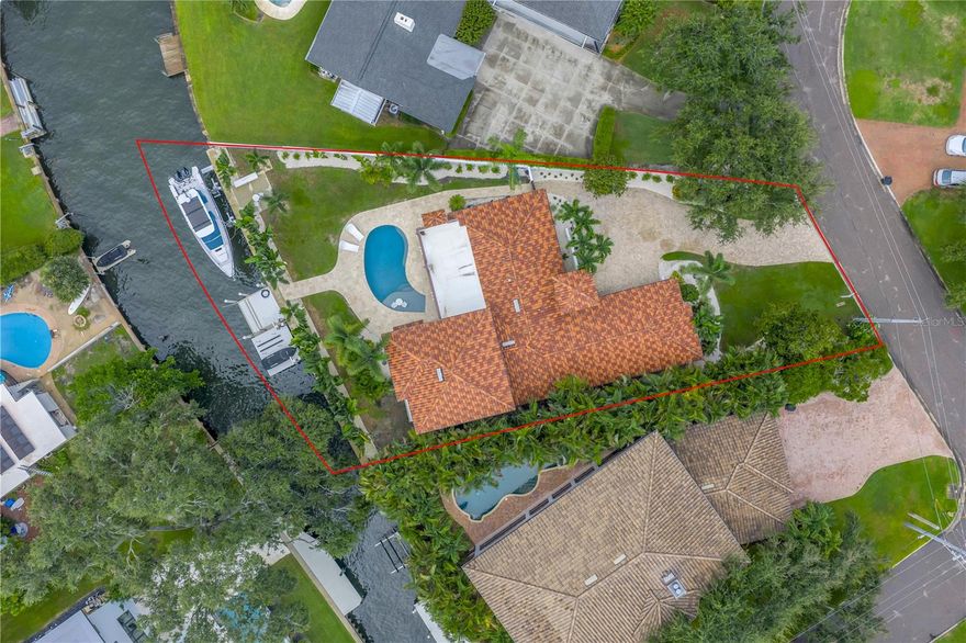 This mediterranean Bay Point Drive oasis on exclusive Snell Island, in the heart of Snell Isle, features an open floor plan, gourmet kitchen and new dock, seawall and two lifts, one 16k pound elevator easily supporting a 40’ vessel plus a 12k pound elevator currently set up for two jet skis, all on a protected canal just seventy-five meters from the stunning open blue waters of Tampa Bay and its countless beaches, bars and restaurants. With four bedrooms, three bathrooms and a large open floor plan blending a gourmet kitchen with new Décor appliances and stainless steel butler’s pantry with a large, comfortable living area, this art lover’s dream boasts integrated entertaining spaces with smart home functionality including Lutron remote lighting, all new LED lighting, exquisite chandeliers by lighting artist Ingo Maurer, in ceiling speakers, electronic privacy shades and much more. Outside, the large, lush, private and secured backyard features a heated saltwater pool with the latest equipment and LED lighting and an oversized covered patio with fireplace providing respite from both hot summer days and cool winter nights. For the auto enthusiast, this home features a tiled 2.5 car garage, amply accommodating two vehicles, a golf cart and all of the water toys necessary to truly enjoy the magic of waterfront St. Petersburg living. Don’t miss the opportunity to view the lowest priced direct water access property on Snell Isle, where you are just minutes from walking, biking, boating or golf carting to all of the amenities and festivals of vibrant downtown St. Petersburg.