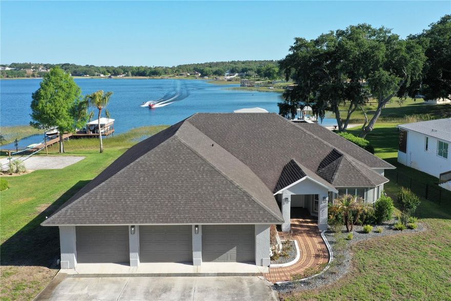 This remodeled lakefront home in Clermont has everything you’re looking for and more. 

Inside, no detail was overlooked. Brand-new front door, LVP flooring throughout, with tile in the bathrooms, freshly textured walls, new baseboards, and all-new cabinetry. The kitchen features new GE appliances, updated countertops, and deep cabinetry for added storage. New shutters have been installed on room windows. There is a private dining room adjacent to the kitchen.

All bedrooms have generous closet space, including a walk-in closet in the primary suite and built-in closets in the additional bedrooms. A bright, open study off the main living area provides the perfect space for a home office or bonus room.

All bathrooms have been fully updated for comfort and functionality. The home is connected to city water, while the irrigation system runs off lake-fed water, with an additional well on site.

The 3-car garage features separate doors, three new motors, and an electrical panel with EV charging station. The A/C ductwork was cleaned in 2024.

The oversized attic, accessible via a pull-down ladder in the garage, offers full standing height, built-in shelving, electricity, and a large fan, ideal for additional storage.

Out back, the oversized covered patio is pre-plumbed and wired for an outdoor kitchen. Two open aired side decks feature brand-new decking. A crawl space under the decking offers endless storage opportunities for your kayak or other water sporting goods.
The dock, built in 2023, includes solid-core plank flooring, an electric boat cover, and full water and electric service.

Located just minutes from Downtown Clermont and Highway 27, with easy access to shopping, dining, and everyday amenities, and approximately 38 miles to Orlando International Airport (MCO), this property combines a quiet lakefront setting with proximity to key Central Florida locations. Low annual HOA fees contribute to manageable holding costs while maintaining the community. 

This home is move-in ready with nothing to do but enjoy the lake!