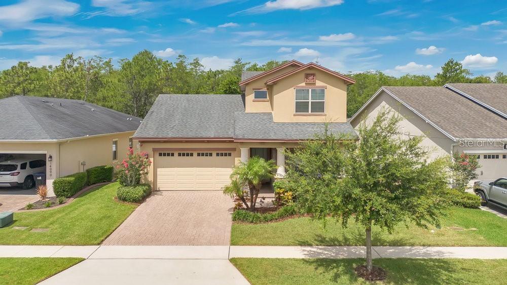 A Home of Quiet Distinction, Built for Today — and Ready for Forever
Welcome to your dream retreat — an exquisitely crafted, 2018-Jones Home USA built sanctuary nestled near the heart of the Waterford Lakes, Eastwood, Avalon Park area, where timeless elegance and modern innovation converge in perfect harmony. Set within a vibrant community that offers resort-style amenities including a recreation center, sparkling pool, state-of-the-art fitness facility, and thoughtfully designed gathering spaces, this home is more than a residence — it’s an experience.
From the very first glance, the home exudes curb appeal with its high-performance shingle roof, full block construction, with decorative stone elevation and an elegant paver driveway and patio, and striking designer coach lighting. The beautifully manicured landscape is supported by a full irrigation system, ensuring lush greenery all year long.
Step inside to a world of refined interiors where every detail has been thoughtfully curated. Rich 18-inch ceramic tile flooring stretches gracefully across the main level, while upgraded plush carpeting softens the private upstairs retreat. Textured walls and ceilings offer a subtle sophistication, accentuated by recessed lighting, custom light fixtures, and deep 5¼-inch baseboards that provide a flawless finish. Classic wood windowsills and crafted door casings lend a custom touch throughout.
The heart of the home — a gourmet kitchen — is a masterpiece of design and functionality. Gleaming granite countertops that accentuate the huge custom kitchen island and 42-inch cabinetry with Moen hardware, upgraded pendant lighting, and a full suite of Whirlpool appliances (including an upgraded washer and dryer) ensure that both form and function are met in equal measure. Every bath continues the luxe theme, with granite surfaces and premium fixtures creating spa-like spaces to relax and recharge.
The owner’s suite, located on the main level, is a true private retreat. Featuring elegant tray ceilings and a spacious spa-inspired en-suite bath and wardrobe.
The lavish upstairs loft is complete with a balcony porch that gazes serenely over a conservation area, where sunsets spill gold across the trees and peace becomes part of your daily rhythm. A fully covered back porch overlooks a generous, fenced-in backyard — ideal for quiet mornings, playtime, or al fresco evenings beneath the stars.
Eco-conscious features such as R-38 attic insulation, R-21 wall insulation, insulated low-E vinyl windows, and smart home digital living technology ensure comfort and efficiency year-round.
And beyond the gates of your personal paradise lies everything you could ever need: premier shopping, dining, and entertainment at Waterford Lakes Town Center, serene trails in the Hal Scott Regional Preserve, and top-tier educational institutions like UCF, Valencia College, and Full Sail University all just minutes away.
This is more than a home — it’s a lifestyle of beauty, comfort, and intelligent design. A place to grow, to dream, and to live fully. Welcome home.
**BUYERS HOA FEES: All closings incur an estoppel fee of $299.00, a capital contribution for the new buyer of $300.00, and a $200.00 transfer fee.