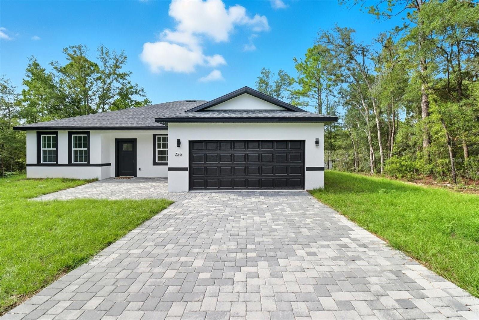 Come fall in love with this beautifully designed NEW CONSTRUCTION home located in Citrus Springs! With an open floor plan, soaring 9'4" ceilings and tile floors throughout, this 4 bedroom, 3 bath home encases warmth & simplicity w/ its stylish fixtures, tones & natural light. This home is great for growing families or entertaining guests, & offers TWO PRIMARY SUITES! Upon entry is the living room & dining area leading into the kitchen equipped with stainless steel appliances, solid wood cabinets, quartz countertops, center island & pantry. The primary suite has two generous walk in closets & bathroom with a walk-in shower & dual vanities. The 2nd suite offers a spacious closet and en suite bath w/ a shower/tub combo. The outdoor space is equally impressive, w/ a pavered driveway & front porch, rear covered lanai & plenty of room to add a pool. Situated in a deed-restricted community with NO HOA fees, Citrus Springs offers access to a local library, community center for social events, lighted tennis courts, and a park for kids. The nearby golf course has a restaurant, putting greens, and driving range. Not to mention, you are minutes away from the Withlacoochee State Trail for hiking & biking, and the world renowned Rainbow River & Springs for kayaking, diving, fishing & all that nature has to offer. Conveniently located just minutes away from restaurants, shopping, medical services, and excellent schools, this home is perfect for creating lasting memories. Don’t miss the chance to make this move in ready home,YOURS. Call to schedule your showing today!