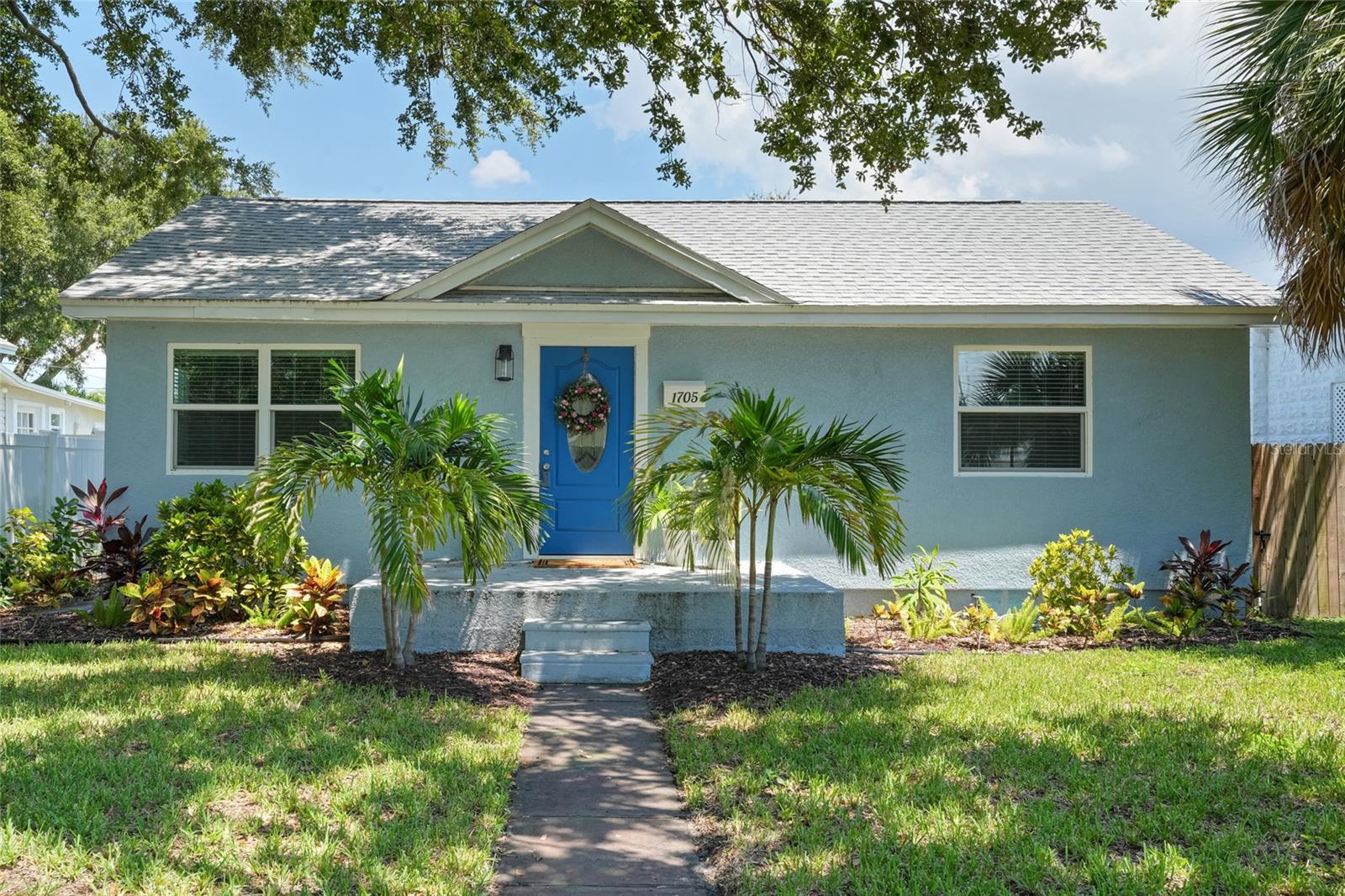 This St. Pete beauty is the total package. Vaulted ceilings with wood beams in the living room, a kitchen straight out of your Pinterest board, and a backyard that feels like your own private oasis, all less than 10 minutes from downtown and NOT in a flood zone!
FULLY RENOVATED just two years ago, this 4-bedroom, 2-bath home blends style and substance with wide-plank vinyl flooring, impact windows and sliders, and a bright, open layout. The kitchen is a showpiece with stainless steel appliances, soft-close cabinetry, and striking quartz countertops.
The living room brings serious wow factor with soaring ceilings and exposed beams that add warmth and charm. Both bathrooms are sleek, spa-inspired, and finished with modern tile and fixtures.
Step outside to a fully fenced backyard designed for relaxation and entertaining, complete with plush turf, privacy clusia hedges, and a spacious covered patio. Hate street parking? Problem solved with a deep, extra-wide two-car garage, ample driveway, and even an attached 8x14 storage room for all the extras.
With the ROOF, HVAC, ELECTRICAL, PLUMBING all updated within the last two years, and new 12' insulation added recently, this move-in ready St. Pete gem checks Every. Single. Box.