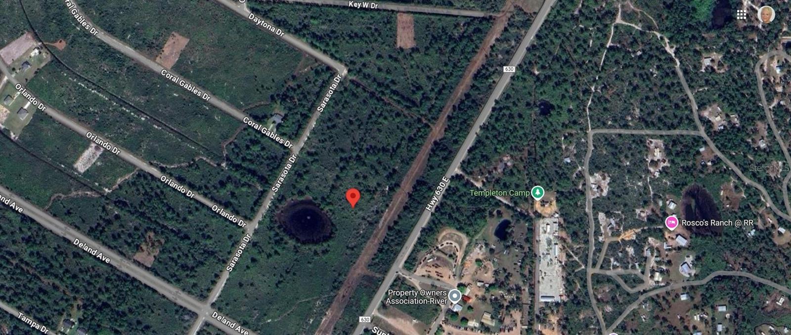 This lot is located outside the gate portion of ILE - Street is not paved only grass - backs up to 630 with a green strip. Nice quiet area the lot is 1/2 acre. No mobile/manufactured homes allowed. You have access to large beautiful Lake Walk In Water, huge fishing, boating recreational lake. One of the largest piers in the area is available to sit and enjoy or fish from. Golf course, tennis courts, pickleball, basketball courts, fitness room and pro shop in the large community clubhouse. This area is a very quiet, tranquil place to enjoy nature at its best. Located off Hwy 60 approximately 18 miles east of Lake Wales. Only an hour to Vero Beach. Check with ILE on building requirements.