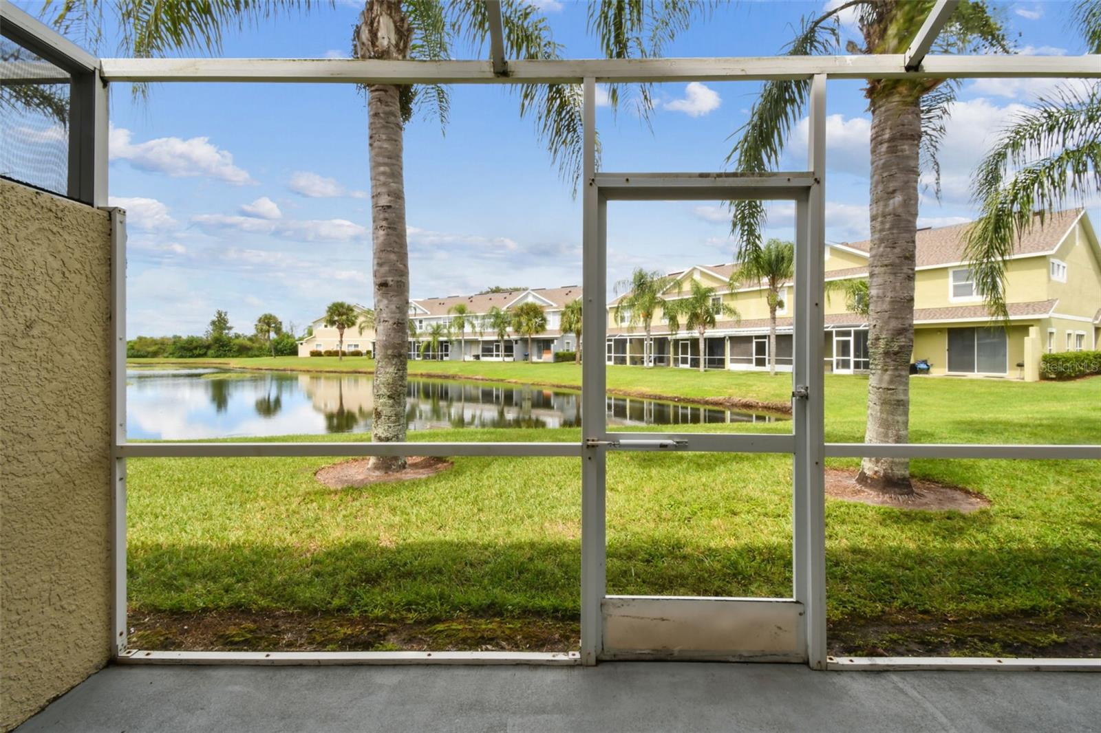 Welcome to 10974 Winter Crest Drive, a move-in-ready WATERFRONT townhome located in the desirable Rivercrest community. This two-bedroom, two-and-a-half-bath home in Riverview offers 1,340 square feet of thoughtfully designed living space. ENJOY MAINTENANCE-FREE LIVING WITH MONTHLY DUES THAT COVER WATER, CONCIERGE AND GARBAGE SERVICES, EXTERIOR INSURANCE, PAINTING, ROOFING, AND LANDSCAPING. The gated entry leads to the front door and opens to a bright interior with tile flooring that transitions into wood-look laminate in the main living areas. The open-concept layout connects the kitchen, dining, and living spaces, creating an easy flow for everyday living. The kitchen is equipped with black appliances, tile floors, bar seating, an eat-in nook, and stylish lighting. A separate dining area, indoor laundry closet, and a convenient half bath round out the first floor. Off the living room, sliding doors lead to a screened lanai with peaceful water views that you are going to love. Upstairs, both bedrooms feature private ensuite baths. The guest room offers a tub/shower combination, while the primary suite includes a walk-in shower and spacious walk-in closet. Fresh NEW carpet has been installed on the stairs and throughout the upper level for comfort.
The townhome faces south in the front and north in the back, helping with energy efficiency. Outside, you’ll find an assigned parking spot, additional guest parking, and an exterior storage closet for extra belongings.
Rivercrest residents enjoy a low-maintenance lifestyle with HOA services that cover water, sewer, valet trash, and exterior upkeep. Community amenities include a pool, splash pad, clubhouse, tennis and basketball courts, and playgrounds. With quick access to US-301 and I-75, this home blends convenience, comfort, and community living.