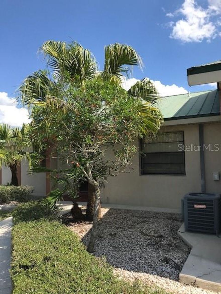 LOVELY END UNIT ONE STORY VILLA.  THREE BEDROOM, TWO BATH IN MULTI-FAMILY COMPLEX.   PRIVATE LOCATION, WITH COMFORTABLE SIDE WALK - WALK UP STYLE, SPLIT BEDROOM LAYOUT WITH CERAMIC TILE, INTERIOR LAUNDRY ROOM WITH FULL SIZE WASHER AND DRYER. APPLIANCES INCLUDE RANGE WITH RANGE HOOD, DISHWASHER & REFRIGERATOR.  PASS THROUGH COUNTER FROM KITCHEN TO LIVING ROOM-DINING ROOM AREA.  SOLID WOOD KITCHEN AND BATHROOM CABINETS WITH GRANITE COUNTERS AND BACKSPLASH IN KITCHEN AND BATHROOMS WIH CULTURED MARBLE COUNTERS.  SCREENED IN LANAI WITH VIEW OF GREENBELT.
 METAL ROOFING, CONCRETE BLOCK CONSTRUCTION.