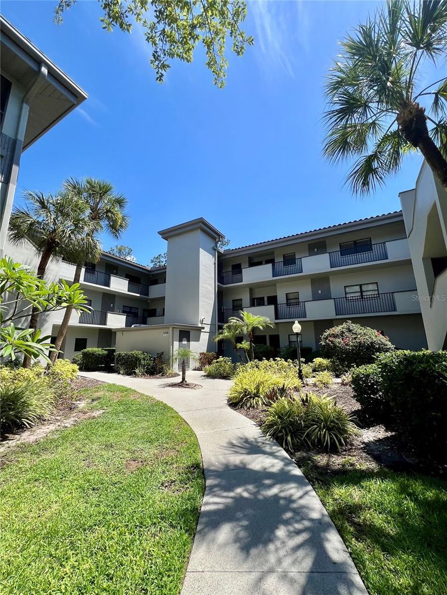 Wonderfully located in the heart of Countryside, this 2-bedroom, 2-bathroom condo offers the perfect blend of convenience and peaceful surroundings. Featuring a functional layout with endless potential to update and make it your own, this home includes a screened balcony with a private storage closet, spacious living areas, and a primary suite with two oversized built-in closets. The interior laundry closet adds everyday convenience, while the elevator, just steps from the front door, provides easy access. Enjoy the comfort of a designated parking space visible directly from the condo, along with additional guest parking conveniently located near the building entrance. Residents can relax and enjoy scenic ponds, benches, and beautifully maintained green spaces, along with a covered gathering area featuring tables and ceiling fans beside the community pool. Water, sewer, and trash are all included. Ideally located just minutes from top-rated beaches, downtown Safety Harbor, Dunedin, premier golf courses, Pinellas Trail, shopping, dining, top medical facilities, a short walk to Countryside Mall, with Tampa International Airport only about 25 minutes away.