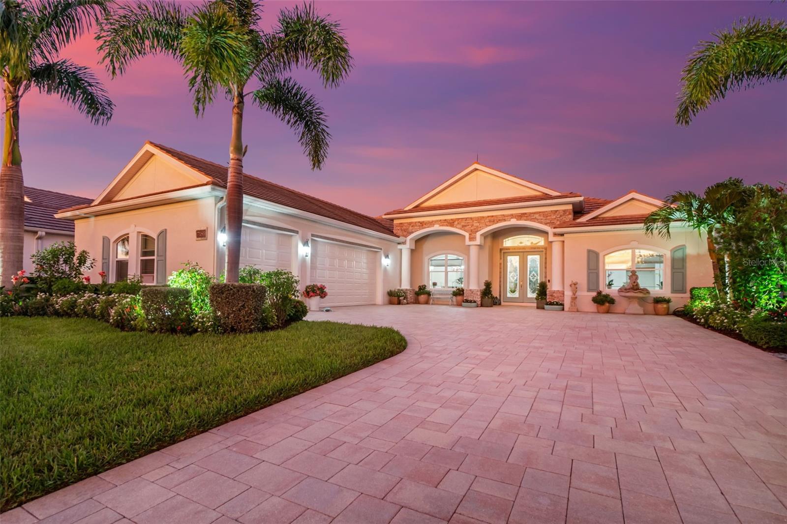 Here in Sarasota’s exclusive Waverley enclave—just 100 homes with unusually low HOA fees—you’ll discover a one-of-a-kind residence that lives like a luxury escape. This expansive 4-bedroom, 3-bath home offers an oversized 3-car garage and a breathtaking great room centered around an enormous kitchen island. Beautiful quartz countertops flow seamlessly throughout, reflecting a carefully curated design aesthetic. Every floor is clad in wood-grain Italian tile, lending warmth and sophistication. Custom pecky cypress trim frames windows and doorways with rich texture, while three rooms are elevated by shiplap-ceiling detailing along with the kitchen island—touches that bring texture, light, and architectural charm to everyday living. Step outside and the allure continues: a heated saltwater pool shimmers beneath the sun, surrounded by lush landscaping and a pergola draped in flowering vines that naturally attracts birds and butterflies, transforming the backyard into a private nature sanctuary. Whether you’re entertaining friends or enjoying tranquil family moments, this outdoor space is a dream. Located in a gated, Medallion-built community prized for its blend of Mediterranean and Caribbean architectural styles, Waverley offers a boutique-luxury setting with low HOA dues and no CDD fees—yet remains close to Sarasota’s top schools, shopping, and beaches. Don’t miss the opportunity to own this thoughtfully upgraded home that masterfully blends upscale finishes, functional living, and a touch of nature.