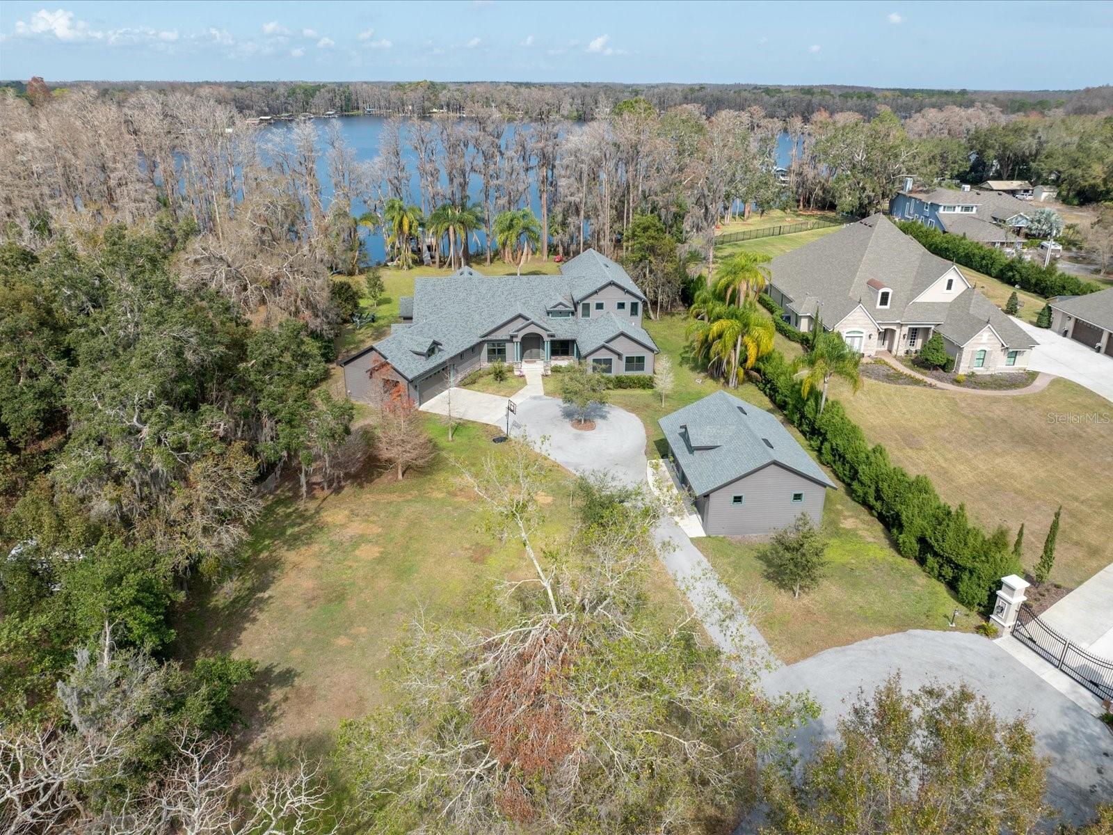 We are pleased to present this MAGNIFICENT, ONE OF A KIND HOUSE situated on a SPECTACULAR 1.76 ACRE, CUL DE SAC LOT on SKI SIZE ROCK LAKE! Built in 2017, and having OVER 150 of lake frontage and access to another nearby ski lake (LAKE JOSEPHINE), this 4 Bedroom, OFFICE, ENTERTAINMENT/GAME ROOM, 4.1 Bath, custom built home with 4,581sq. ft. of incredible living space, features: a light and bright, open floor plan with volume ceilings and neutral décor; a SPECTACULAR KITCHEN with stainless steel appliances, quartz counter tops, enormous island and walk in pantry; a GREAT ROOM sure to please, offering lake views, high ceilings with decorative beams, transom windows, plenty of room for entertaining or simply relaxing, custom built ins, and a gorgeous fireplace; a spacious, FIRST FLOOR PRIMARY SUITE with two large walk-in closets and beautiful master bath; TWO EN SUITE, FIRST FLOOR secondary bedrooms; a fourth bedroom upstairs with full bath and located adjacent to a LARGE BONUS ROOM with covered deck that offers amazing lake views; French doors and hardwood floors; HUGE SCREENED LANAI with hot tub, great for entertaining; TWO CAR ATTACHED garage and THREE CAR DETACHED garage; HOUSE GENERATOR; covered dock with lift; immaculate interior/exterior condition and much more! Add to these a CONVENIENT LOCATION for schools, shopping, dining, medical facilities, and interstate travel, and you have a fantastic place to call home!