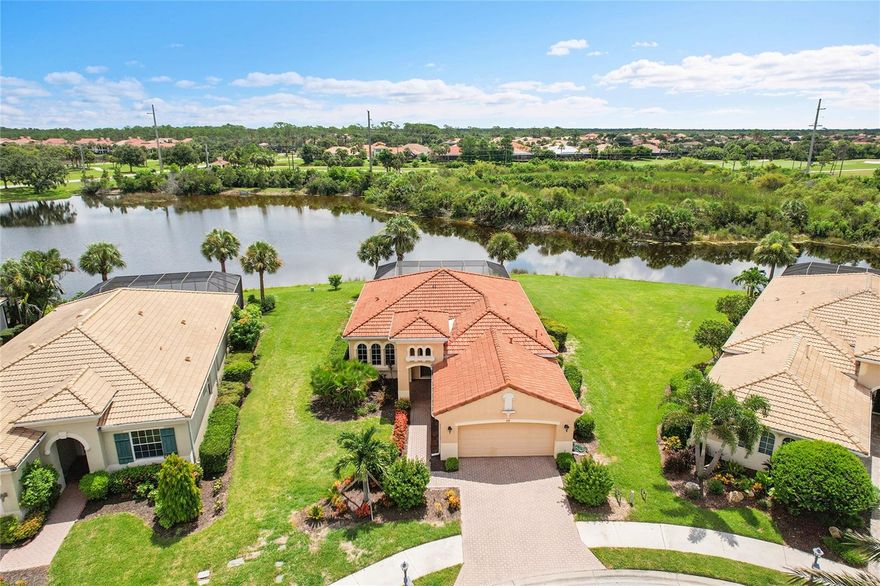 THIS is one of the LARGEST lots with one of the best views! Imagine yourself living lakefront HERE in Venetian Golf & River Club! Welcome to a serene cul-de-sac haven; this stunning 3-bed, 2-bath waterfront home sits on an expansive lot overlooking the community’s deepest spring-fed lake. With no flood zone concerns and views that elevate every sunrise and sunset, this delightful retreat offers both peace and reassurance. Prepare meals effortlessly in a well-appointed kitchen, boasting granite countertops, elegant wood cabinetry, and sleek stainless-steel appliances. The seamless flow into the inviting living room makes entertaining and everyday living a breeze. Indoor-outdoor flow at its best. Sliding glass doors create a connection to your screened-in lanai—your private oasis featuring a sparkling pool and spa. Need a quiet moment? A private entrance from the master suite lets you slip outside in complete tranquility. Elegant tile flows through the living spaces, while plush carpeting adds comfort in the bedrooms, striking the perfect balance between style and coziness. Located in the Venetian Golf & River Club of North Venice, this property gives you access to remarkable lifestyle amenities: a 18-hole championship golf course, par-72 and designed by renowned architect Chip Powell, and a 20,000 sq ft Mediterranean-inspired River Clubhouse offering both elegant and casual dining options, with stunning views of preserved natural landscapes. Other amenities include a resort-style pool, lap pool, spa, poolside Tiki bar, fitness center with professionally led classes, and six Har-Tru tennis courts (plus newly added pickleball courts). There is an enchanting 70+ acre nature park with a boardwalk woven through wetlands and wildlife habitats—perfect for birdwatching, walking, and reconnecting with nature. Picturesque views abound; many residences frame golf, lake, or nature preserve vistas for a peaceful backdrop. Residents live a blend of luxury, nature, and recreation from the pristine beaches of Venice Island and Casey Key to proximity of I-75, Sarasota, and local conveniences. This isn’t just a property... It’s a launchpad for the lifestyle you envision. Waterside mornings and sunset reflections on your private lanai, effortless access to outstanding culinary, recreational, and nature-filled amenities can be your reality. Don’t miss your chance to step into this blend of comfort, community, and natural beauty. Schedule your tour today and experience the Venetian Golf & River Club lifestyle—where serenity meets sophistication.