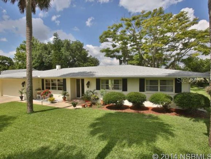 Act now before its too late. Golf course homes like this one - sell fast and rarely re-list.  ...This 1963 home has been tastefully updated with unique features that fit the style and elegance of the home. Large, formal entryway/foyer Crown molding and high ceilings, intricate woodwork, custom mahogany laminate flooring 3 1/2 wide with custom baseboard, galley kitchen with coffered ceiling and recessed lighting, large windows over looking the golf course, open plan living/dining room with working wood burning fireplace. . Additionally  both bathrooms have been remodeled one featuring cultured marble. Natural light floods the home, with the rear wall lined with large windows, sliders & a set of French doors in the master suite, providing an open, airy quality to most of the living spaces  unique  15 x 6 hobby, workshop or craft  room off the 2 car garage  The fenced back yard backs up to the New Smyrna Golf Course, & both front & back yards are landscaped and neatly manicured and there is a large L-shape poured concrete patio in the back to enjoy the view.  The 30 year roof is  new as of September 2012, and the home has gutters and a sprinkler system.    Measurements presumed accurate but not guaranteed. Excludes Living, Dining and Family window treatments ;Water: City