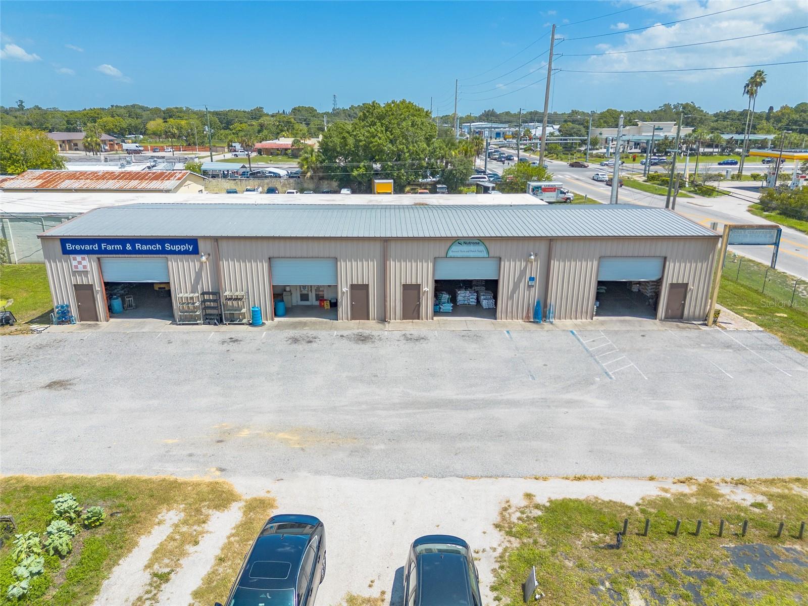 This exceptional 9-acre commercial property in Central Florida offers a rare and versatile investment opportunity. Zoned BU-2, Brevard County's most extensive commercial classification, the land is permitted for a wide range of uses including retail, wholesale, warehousing, contracting services, heavy repair, and even outdoor storage. The property currently operates as a retail feed and farm supply store and features a 4,800 sq/ft, 4-bay warehouse with 17-foot ceilings and 12-foot roll-up doors on each bay. One bay includes 600 sq/ft of air-conditioned space, ideal for retail or office use, and all bays are already plumbed for individual restrooms making the structure functional for immediate business operations or adaptable for future development. The location is unbeatable just 15 minutes from Cocoa Beach, and only 35 minutes from both Orlando International Airport and Kennedy Space Center. The central positioning within Brevard County ensures easy access to major transportation routes and high-traffic areas. The BU-2 zoning designation allows for nearly unlimited commercial potential, whether you're interested in building storage units, operating a retail or wholesale business, manufacturing goods, running mechanic services, or developing a more extensive commercial complex. This property offers unmatched flexibility and growth potential for business owners, investors, or developers looking to take advantage of one of Florida's most accommodating commercial zones. With its size, infrastructure, and location, this is truly a unique opportunity to establish or expand a high-impact commercial operation in a thriving region.