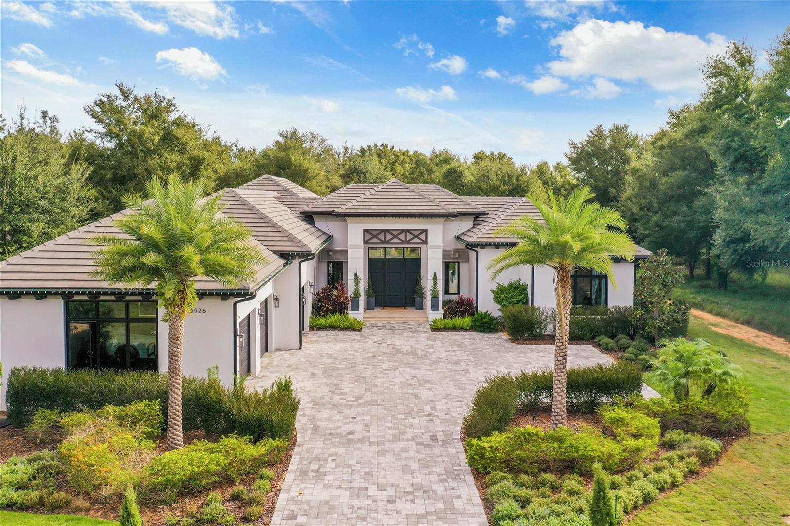 Uncover the pinnacle of luxury living in this charming model home, crafted by Jennings Builder with upgrades that extend from floors to ceilings. Impeccably maintained, this property showcases recent enhancements, including a freshly resodded backyard featuring lush Zosia grass in October 2023, creating a vibrant green oasis for outdoor activities. The electrical, irrigation, and air conditioning systems underwent meticulous maintenance.
Nestled in the prestigious Bella Collina, a gated community sprawling across 1,900 acres, this single-story masterpiece offers a 5-bedroom, 5.5-bathroom sanctuary on 1.28 acres. With soaring ceilings exuding elegance, the open-plan layout divides into two sides. One side boasts 3 guest bedrooms, a kitchen, dining room, and laundry/butler pantry, while the other features the master suite, office, and fifth guest bedroom. A captivating pool with a hot tub serves as the centerpiece, complemented by a generously sized lanai housing a summer kitchen, outdoor dining, sofas, and a fireplace.
The kitchen is equipped with top-of-the-line Thermador appliances, an expansive island, upgraded wall tile, and a walk-in pantry. The master suite offers pool views, a seating area, and a spacious ensuite with a freestanding tub and frameless glass shower. A private office with large windows provides an ideal work-from-home space.
Bella Collina's amenities include an 18-hole golf course designed by Nick Faldo, tennis and Pickelball courts, a fitness center, spa, resort-style pool, and exclusive dining options. Conveniently located near Montverde Academy, this residence offers an unparalleled Florida lifestyle. Don't miss the opportunity to own this upgraded and meticulously maintained home—contact us today for a viewing. All fees and measurements to be verified by the buyer. Information is subject to errors, omissions, and changes without notice.
All fees and room measurements are to be verified by the buyer. All information is subject to errors, omissions, and changes without notice.