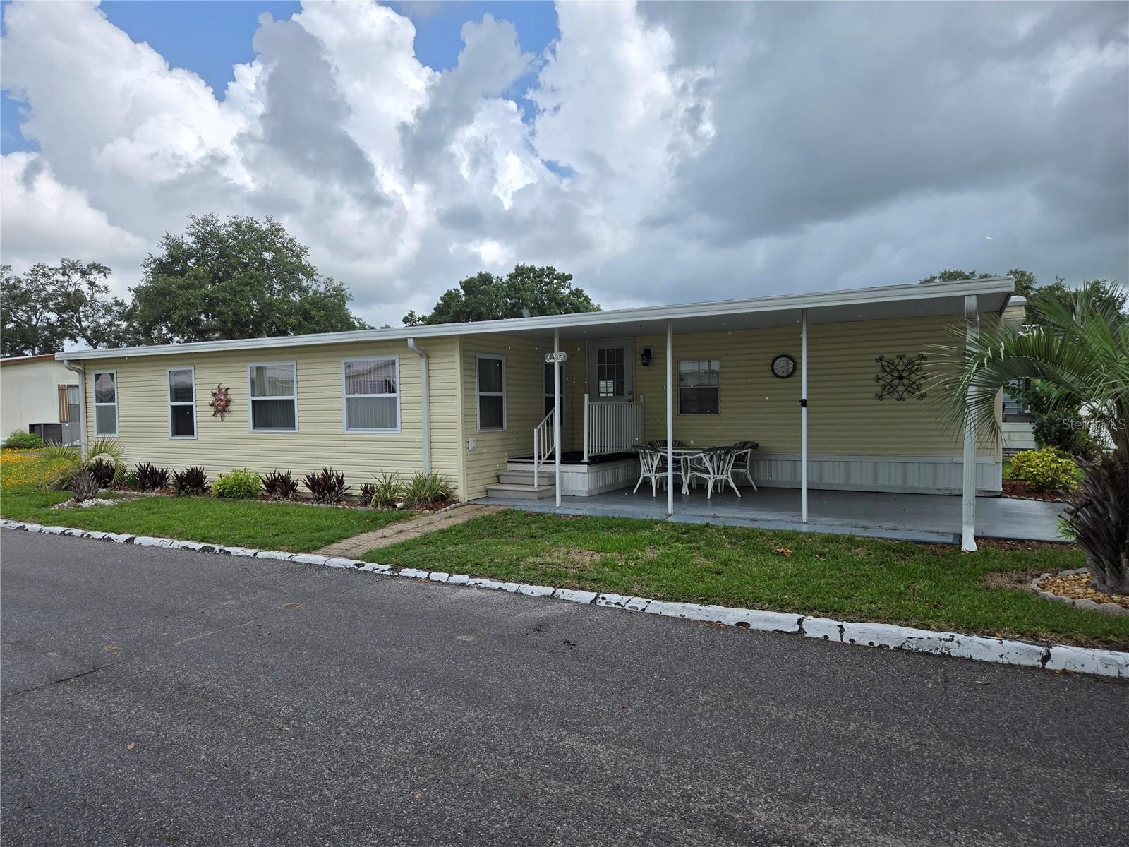 Welcome HOME to Country Aire Villages (55+). This is a co-operative Mobile Home Community with LOW ($130) monthly fees which include cable TV and internet also water, sewer, & trash. This Home has been loved for many years. The A/C is Newer and the roof is AMS which is the best roof on a mobile home. For a single wide, this is boasting with loads of space to spread out. Non Smoking owners and fully furnished. What more could you ask for? The view from the front of the home is a 5 acre field. As you enter, you are welcomed by a beautiful outdoor sitting area under the carport. A perfect space for entertaining neighbors and friends. As you enter the home there is a beautiful updated kitchen with wood cabinets. Off the kitchen to the right is a perfect space for a 3rd bedroom, crafting room, guest room or office space. The half bath is in this front room for convenience. Pass through the kitchen into the dining room where you have a beautiful space to seat 6. The dining room has a media center at one end to place all your electronics. Enter the spacious living room and enjoy the faux fire place while you relax. The primary bedroom is just off the living room with a full bathroom just to the right. The third bedroom is at the end of the hall with access to the side yard. Come and see this gem before it is gone.