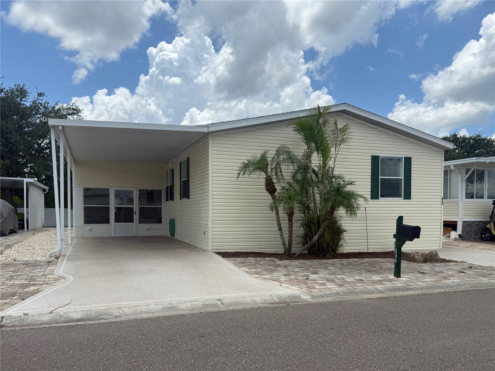 WELCOME to this spacious home in the resort-style 55+ resident-owned waterfront community of Caribbean Isles. If you're ready to make a move, this 1620 square foot, three-bedroom, two-bath home is ready for your seasonal enjoyment or year-round retirement. The home features a large SCREENED IN LANAI, a dedicated laundry area with ample storage and workspace, and a separate WORKSHOP with plenty of room for hobbies or DIY. The kitchen opens to the dining and living areas while maintaining a sense of separation—perfect for perfecting your cooking skills. The primary suite will comfortably accommodate a king-sized bedroom set and is thoughtfully separated from the guest rooms on the opposite side of the expansive living room. A private office area, enclosed, and just off the kitchen, offers a quiet workspace or hobby nook. Additional features include HIGH CEILINGS, large windows that fill the home with natural light, and a walk-in shower. Caribbean Isles is a WATERFRONT COMMUNITY built along a series of canals, with concrete seawalls, that lead out to Tampa Bay. Residents can take advantage of BOAT AND RV STORAGE in the community lot for an affordable annual fee ranging from $120 to $250, depending on space needs. The community is GOLF CART and PET FRIENDLY. Located midway between Tampa, St. Petersburg, and Sarasota-Bradenton, and within a day trip to Orlando’s theme parks, Caribbean Isles offers both tranquility and convenience. Apollo Beach provides everything you need locally—from shopping and dining to recreational activities. There is NO LOT RENT. Ownership includes a share in the resident-owned cooperative. The monthly maintenance fee of $242 covers professional management, upkeep of private roads, a boat launch, dog park, lagoon park, community amenities, and funding for replacement reserves.