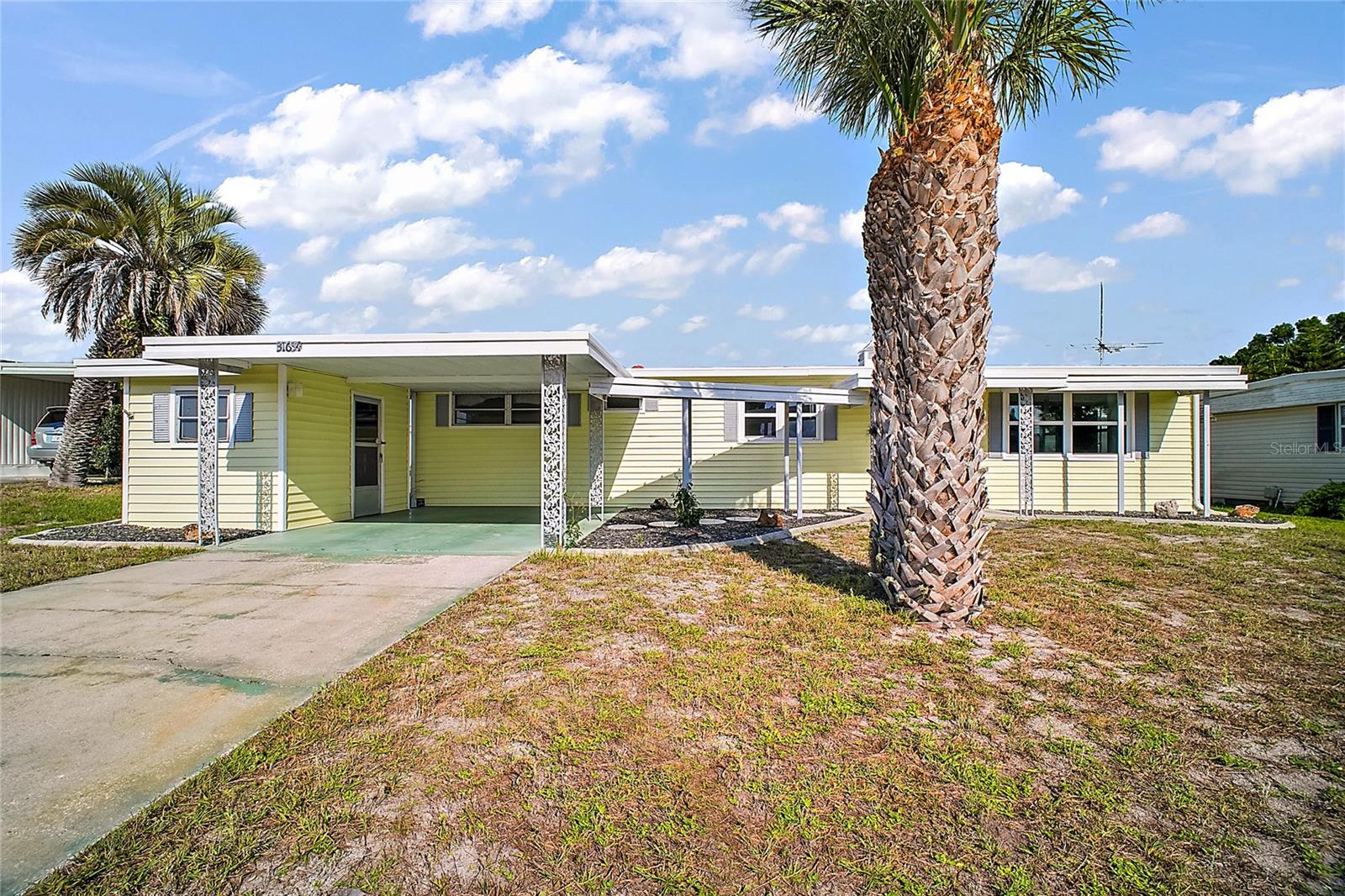 PRICE REDUCTION! This well maintained home in the sought after Imperial Terrace West Community has 2-bedrooms and 2-baths. Vinyl floors throughout. Upgraded wood kitchen cabinets as well as a large pantry. Ceiling fans throughout the home keep it cool, along with central A/C. Toilets have been updated. There is a screened in Florida room for privacy in the back. Also is an outside laundry/storage room. Other amenities include boat docks for rent, a large clubhouse with shuffleboard court and indoor swimming pool with jacuzzi. There are lots of activities planned throughout the year. Golf cart friendly, this is a 55+ community - and you own your own LOT!! Come check it out!