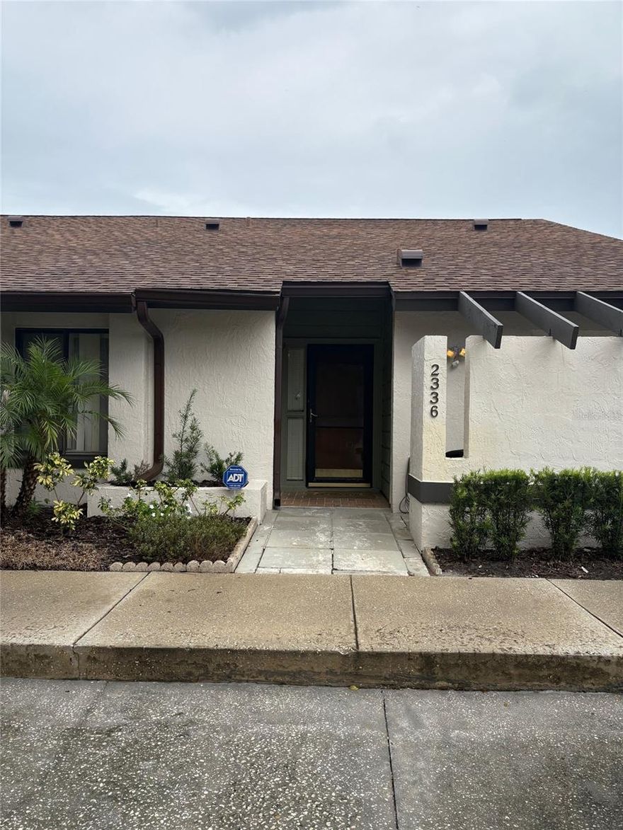 PRICED TO SELL!!! This is the largest floorplan in the community. Two bedrooms, two bathrooms, and a loft that you can use as a third bedroom, home office, or gym. Welcome to the established and well-maintained community of Cedarwood Village, located in highly desirable Winter Park! TREE-LINED STREETS lead you to this two-story, 2-bedroom, 2-bath BLOCK-CONSTRUCTED condominium offering 1,669 square feet of interior living space, this includes an enclosed lanai (under air), for extra living space. The open living and dining area features VAULTED CEILINGS, two skylights, creating a bright and inviting space. From here, enjoy serene views of the enclosed lanai and lush green space beyond. A WET BAR adds a perfect touch for entertaining. Upstairs the loft has a skylight, ceiling fan and is carpeted. The kitchen is thoughtfully designed with a space for a charming eat-in nook that overlooks your PRIVATE COURTYARD and is accessible through sliding glass doors—perfect for morning coffee or outdoor dining. For added convenience, the laundry closet with a WASHER AND DRYER is tucked right into the kitchen. The primary suite is a peaceful retreat, with a beautifully en-suite bathroom with a brand-new vanity with granite, featuring both a WALK-IN closet, and a shower enclosure and the lanai under air, is accessible through sliding glass doors. The spacious second bedroom also features a walk-in closet and attached access to the second bathroom, offering privacy while still serving guests comfortably. Additionally, this home is located across from green space, has two designated parking spaces, and a private mailbox. Re-roofed and new skylights were installed in 2020; entire complex was recently painted. Upgrades include newer AC, and a beautiful master bathroom cabinet and sink —providing comfort and style. With low HOA dues, residents enjoy access to a sparkling community pool, clubhouse, tennis and basketball courts, pickleball, a FENCED DOG RUN, and a pet walk with waste stations. Monthly fees also cover roof and exterior building maintenance, pest control, and landscaping. This ideal Winter Park location is just minutes to Park Avenue, UCF, Rollins College, Full Sail University, shopping, restaurants, entertainment, and medical facilities.