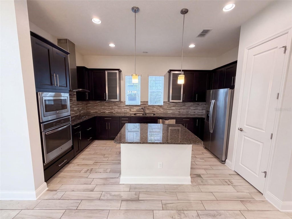 Photo of 7797 Laureate Boulevard, Orlando, FL 32827 (MLS # O6442009)