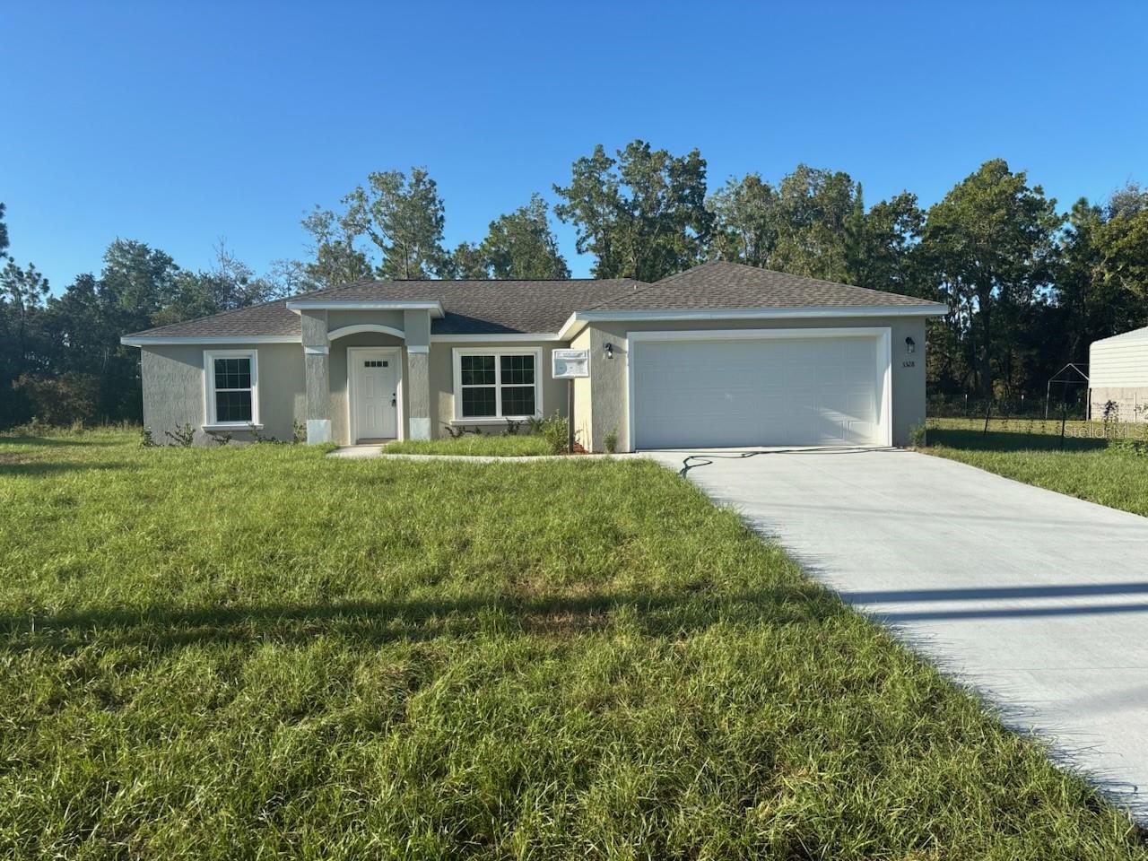 NEW CONSTRUCTION. MOVE-IN READY! This beautiful Islamorada Model offers 3 bedrooms, 2 bathrooms, and 1,438 square feet of comfortable living space. Built with solid concrete block construction and a durable 30-year architectural shingle roof, this home combines quality and style. Energy-efficient double-pane windows fill the vaulted living room with natural light, while luxury vinyl plank flooring runs seamlessly throughout. The kitchen is designed for both beauty and function, featuring stainless steel appliances, custom white shaker cabinets with a full upgraded cabinet package and soft-close drawers, a pantry, granite countertops, and a subway tile backsplash. The master suite includes a glass-enclosed shower with upgraded marble-look tile, while the guest bath offers a tub/shower combo with matching finishes. A laundry room with upgraded cabinetry adds convenience. Enjoy a covered patio, an attached 2-car garage with opener and remotes, and the peace of no HOA fees. Located in flood zone X, this home is high and dry and does not require flood insurance.