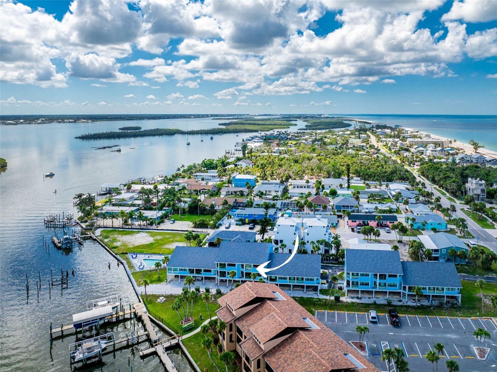From Sunrise Over the Bay to Sunsets on the Gulf, This Rare Sandpiper Cove Condo Will Make Every Day Feel Like a Vacation! This spectacular turnkey furnished two-bedroom, two-bath condo offers water views of both the Bay and the Gulf from multiple windows and a glass-enclosed balcony. The heated bayfront pool is an ideal spot to spend afternoons, whether you’re enjoying happy hour with neighbors or simply relaxing as dolphins pass by. For added peace of mind, all windows are impact rated, the roofs were replaced in 2022, and the community docks with electricity are being renovated and expanded to four slips for this 14-unit complex. Inside, you’ll find a well-maintained, light-filled living space with vaulted ceilings and thoughtful updates completed since 2020. These include new kitchen and bath cabinetry, LVP flooring in the hallway, dining area, and kitchen, new carpeting in the remaining rooms, fresh interior paint, updated overhead lighting and ceiling fans, and a new A/C system installed in 2022. The kitchen features an abundance of cabinetry, solid surface countertops, and a convenient pass-through with a breakfast bar, allowing you to cook while staying connected with family and guests. The spacious living room opens to a glass-enclosed balcony through sliding doors, extending your living space and offering gorgeous bay views where you can relax and watch the boats go by. The ensuite primary bedroom also has sliding doors for balcony access, so you can wake up each morning to sparkling water views. It features newer mirrored closet doors, wood laminate flooring in the bathroom, a built-in Jacuzzi tub, an oversized double-sink solid surface vanity, and a fully tiled step-in shower. The additional bedroom has a nice-sized reach-in closet, and the guest bathroom is well equipped with an oversized single-sink vanity and a tiled tub and shower combination. Additional highlights include an indoor laundry closet, two assigned under-building parking spaces, and a storage closet for all your beach accessories. The Sandpiper Cove lifestyle includes a heated bayfront pool, renovated docks, and deeded beach access just across the street. This Manasota Key location is ideal, as it is close to everything. You can easily walk, bike, or take the golf cart shuttle to several local restaurants, tiki bars, and fun nightlife. If you are looking to spend the day on the water, there are boat and jet ski rental companies nearby. Cross the bridge into Englewood and you will find shops, restaurants, medical facilities, parks, golf, pickleball, and historic Dearborn Street with its year-round events. These units are self-managed and require a 30-day minimum rental period, giving you the flexibility to enjoy the condo for yourself or generate investment income. Do not wait, this unique opportunity will not last long. Make an appointment today to see 1745 Gulf Blvd in Sandpiper Cove.