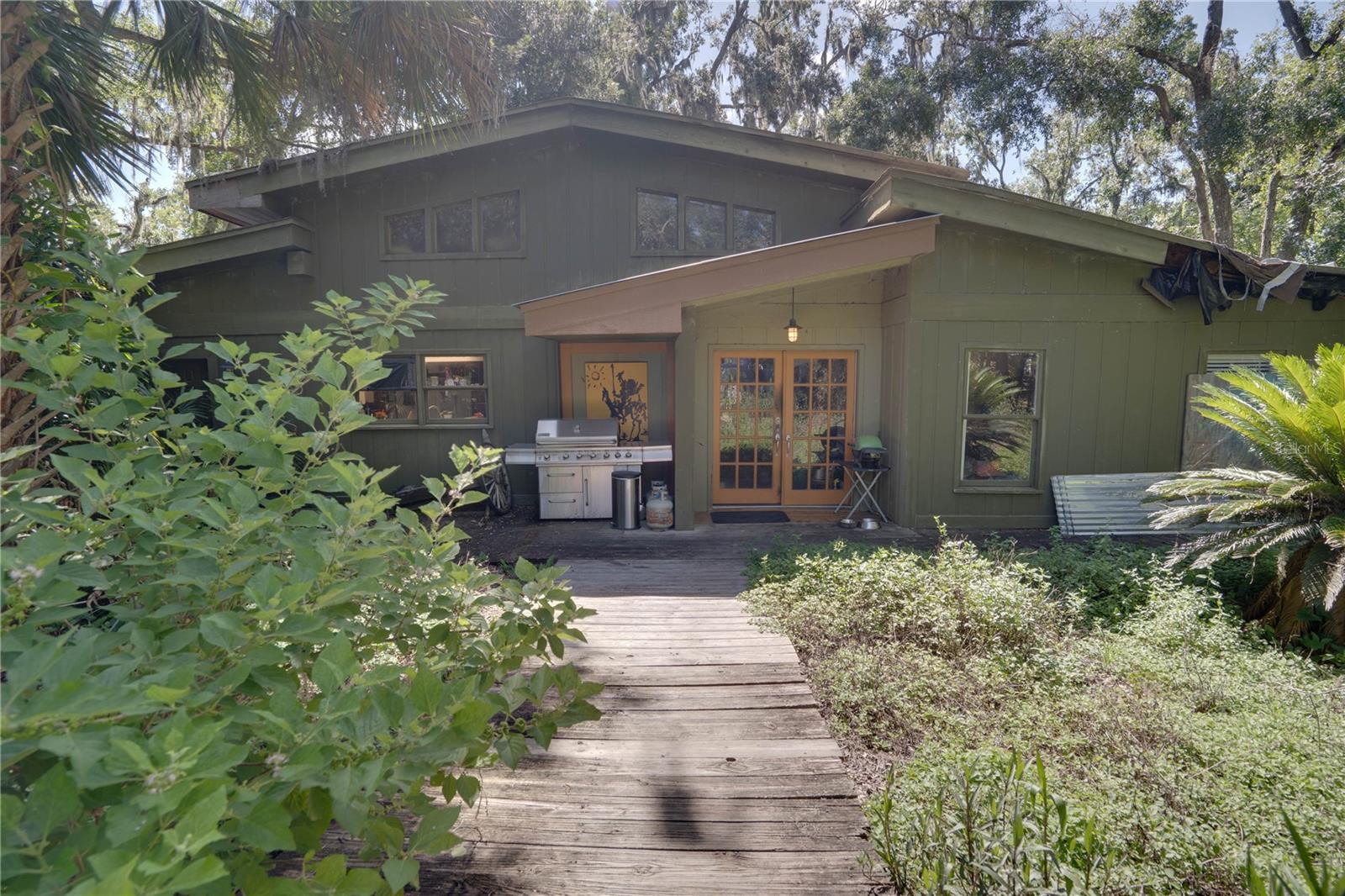 Rare riverfront opportunity with 3.5 ACRES and over 600 FEET OF PRIVATE ALAFIA RIVER FRONTAGE and possible OWNER FINANCING, located just minutes from the mouth of Tampa Bay.
This unique property features a 3-STORY BOAT DOCK situated in deep water, ideal for sailboats or other large marine craft.
The main home offers unique design potential but will require a FULL RENOVATION OR TEAR DOWN — CONTRACTOR BIDS HAVE ALREADY BEEN OBTAINED and can be provided to serious buyers upon receipt of AS IS contract.
A separate OFFICE BUILDING WITH A 2,000 SQ FT ATTACHED GARAGE offers endless possibilities for a home-based business, studio, or guest space.
The land also features TWO NATURAL SPRINGS, a SMALL CREEK, mature trees, and expansive open green space. One of the natural springs can be DAMMED OFF TO CREATE YOUR OWN SPRING-FED NATURAL POOL — please inquire for more details.
Utilities are already in place, along with TWO FULL TRANSFORMERS to support a MULTI-TENANT OR EXPANSION CONFIGURATION. This is your chance to build your PRIVATE WATERFRONT RETREAT, family compound, or explore development potential.
Located in HIGHLY DESIRABLE RIVERVIEW, you’ll enjoy convenient access to shops, restaurants, downtown Tampa, and the area’s beautiful beaches. CASH, RENOVATION LOANS, OR PRIVATE FINANCING OPTIONS ARE AVAILABLE — ask for details. Shown by appointment only — schedule your tour of this rare waterfront opportunity today!