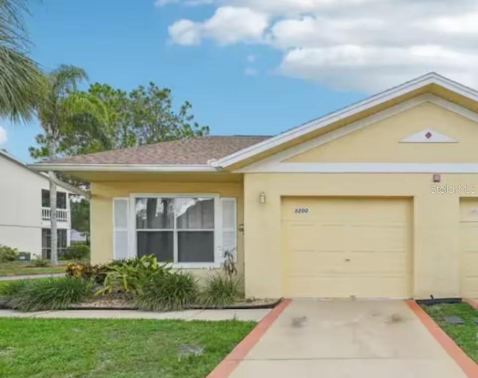 PROFESSIONAL PICTURES COMING SOON....INVESTORS Discover this prime income-generating opportunity near Disney! This impressive home offers versatile use as a short-term or long-term rental, or as your personal residence. Notable for its remarkably low HOA fees, this property stands out in the area. Enjoy a range of amenities including an oversized pool, hot tub, gym, BBQ area, and tennis court—all maintained by the HOA, which also handles exterior upkeep. Boasting a coveted location just 5 miles from Disney Theme Park, this single-level townhome with vaulted ceilings offers a spacious feel. The attached garage has been converted into a bonus room. Recent updates include a new roof (2022) and beautifully remodeled Kitchen Cabinets. The property also features a charming screened-in patio for relaxation. Conveniently located near the pool and mailbox, this property promises both comfort and value, whether you choose to live here or capitalize on its rental potential.