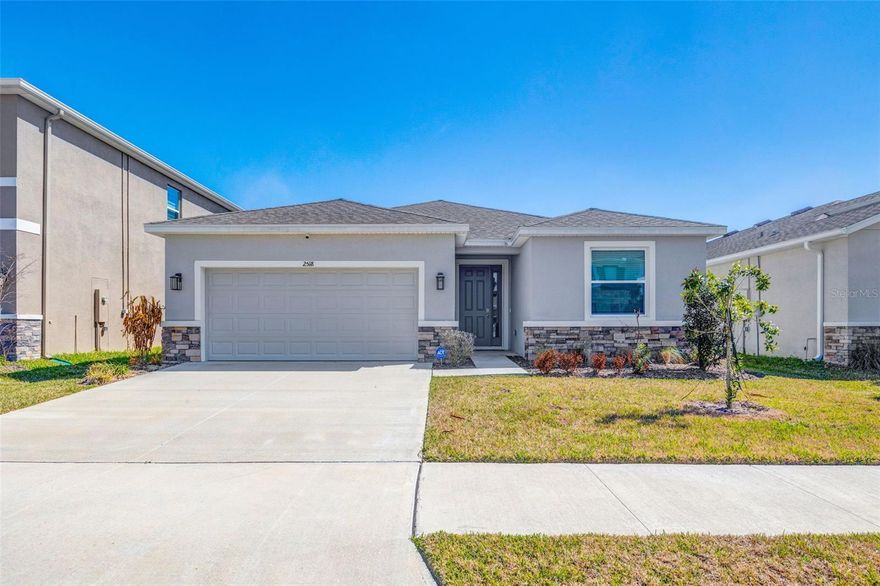 TURN-KEY, MOVE-IN READY, LIKE-NEW (ONLY 2 YEARS OLD), POPULAR LANTANA MODEL, 4 BEDROOMS, 2.5 BATHS, 2-CAR GARAGE, 2,045 SQ FT, UPGRADED HOME IN WOODCREEK COMMUNITY WITH TOP WESLEY CHAPEL SCHOOLS — Welcome to this stunning one-story single-family home situated on a quiet street in the desirable Woodcreek community. Better than new and loaded with upgrades, this open-concept home features a modern kitchen with stainless-steel appliances including dishwasher, range, microwave, French door refrigerator, plus washer and dryer included. The spacious layout flows seamlessly into the living and dining areas, with sliding doors leading to a covered lanai—perfect for relaxing or entertaining. The primary suite offers a full bath, dual vanities, and separate his-and-her closets, while two additional bedrooms share a full bath and a fourth bedroom sits near a powder bath and laundry room for added flexibility. Upgrades include blinds throughout, upgraded security system with cameras and motion detector, five ceiling fans (all bedrooms and living room), updated door hardware and bath accessories, reverse osmosis water filtration system, 240-volt EV outlet in the garage, and two exterior light fixtures at the garage. Community amenities include a pool, playground, and walking trails, all just 5 minutes from Wiregrass Mall, restaurants, and hospitals, and approximately 15 minutes from I-75 and Tampa Premium Outlets—ideal for those seeking comfort, convenience, and style in Wesley Chapel.