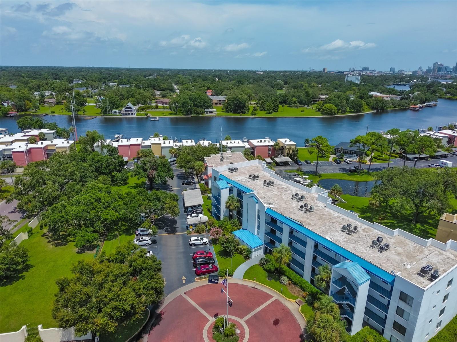 FOR LEASE, LEASE OPTION OR FOR SALE. Welcome to this MAINTENANCE-FREE, 3-bedroom, 2-bath condo located on the third floor (ELEVATOR IN BUILDING) of the highly desirable gated Marina Club community, Building L. This spacious unit offers an open floor plan with ceramic tile flooring throughout, a bright and functional kitchen featuring wood cabinets and a convenient pass-through breakfast bar, and a large screened-in patio accessible from both the living room and the primary bedroom. The primary suite includes a walk-in closet and a private bath with a step-in shower. Stackable washer and dryer combo included for added convenience. The unit also comes with a designated open parking space, and the building features elevator access for easy entry. Set along one of the widest stretches of the Hillsborough River, The Marina Club offers a true waterfront lifestyle with a wide range of amenities. Residents enjoy access to two riverfront pools, a jacuzzi, a clubhouse with a fitness center overlooking the river, tennis and racquetball courts, a dog park, and a scenic riverwalk perfect for morning jogs or evening strolls. Boat slips with deep water access to the Gulf are available on a waitlist basis with additional fees, and the community also provides a boat ramp and trailer parking. The monthly lease fee includes exterior maintenance, cable, internet, water, sewer, and trash service. The location is unbeatable—just minutes from Downtown Tampa, SOHO, Riverwalk, Channelside, Armature Works, Raymond James Stadium, and I-275—offering easy access to the best shopping, dining, and entertainment the city has to offer. Enjoy beautiful river and skyline views in this well-maintained, amenity-rich community that perfectly blends comfort, convenience, and a true Florida waterfront lifestyle. Call today!