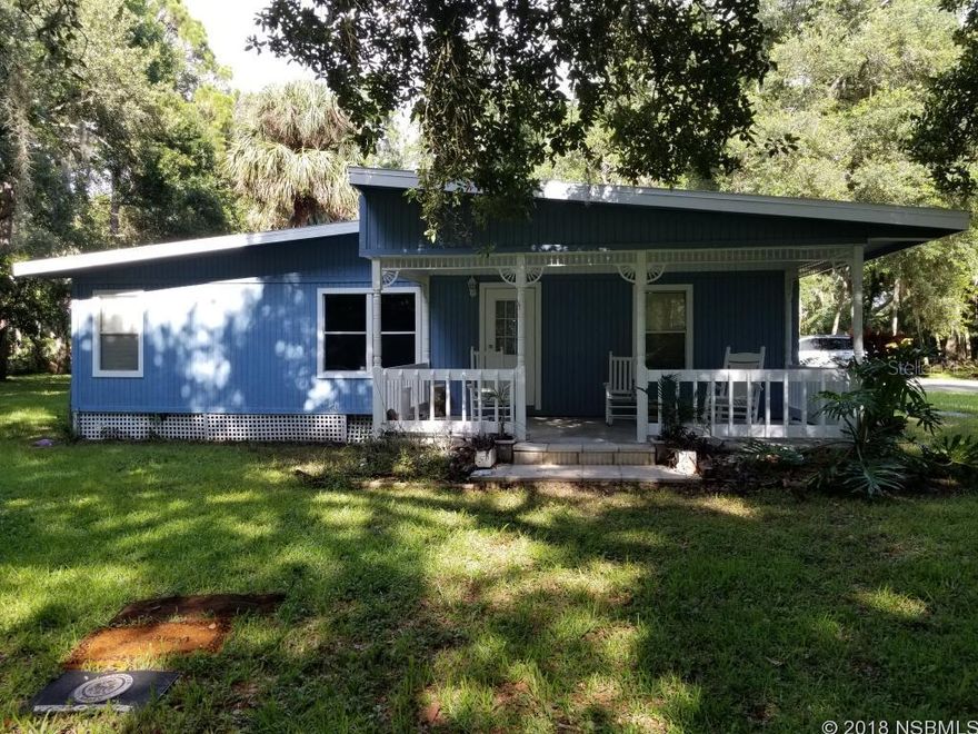 Mobile Home with Barn in Edgewater situated on 2.67 Acres featuring towering majestic oak trees and lush vegetation. A little TLC will go a long way with this gorgeous piece of property. If you are looking for privacy look no further. Bring the horses...Come take a look before it is gone. All measurements are approximate so please verify.