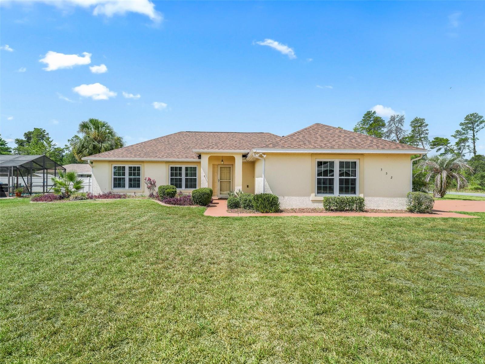 Don't pass this one by! Meticulously maintained, 1500+ sq ft under heat and air 3/2 with 2 car side entry garage PLUS a 417 sq ft Florida Room/Lanai. A/C 2020, New Roof 2024, New Hurricane Resistant Windows in 2024, New Carpet throughout living areas, Tile in the entryway, the breakfast bar area and the bathrooms. New LVP in the Kitchen and Laundry Room. New exterior paint in 2022, and irrigation system connected to a well for low cost lawn care, Whole House Water Softener. Gorgeous mature landscaping with curbing and red volcanic rock beds, gutters and downspouts, fenced in backyard with shed that matches the home.
Inside the kitchen boasts tons of cabinetry, a large farmhouse size stainless sink, all newer black appliances including a built-in microwave, glass top stove, fridge with ice and water in the door and a dishwasher. The inside laundry room features high end Maytag Neptune washer and dryer set that convey. Do you need closet space? The primary suite has a large walk-in, plus two linen closets in the en-suite with large glass enclosed step-in shower, dual sinks and lots of cabinetry and counter space. This is a split plan, the guest side of the home has good size closets in both bedrooms as well as a linen closet. Ceiling fans in all the rooms with lights. The lanai has doggy doors installed for your furry friends and newer indoor/outdoor carpet. There is a ceiling fan in the lanai and multiple electrical outlets. It could easily become climate controlled with a portable A/C unit. Home is about 2 minutes from the entrance to the community with the water fall on 484. Catty Cornered to the sports complex and just a few blocks to Walgreens and other shopping. Move in ready.