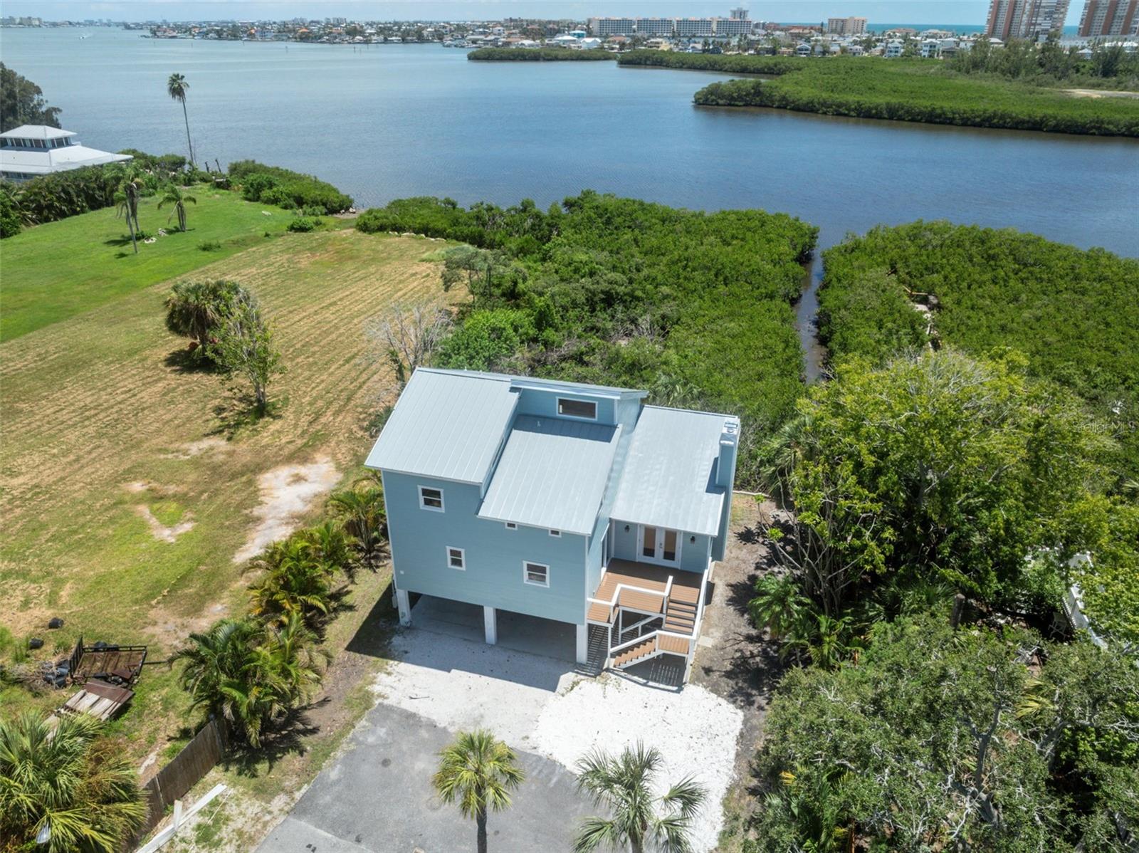 Waterfront sanctuary with sweeping bay views in the heart of Seminole! Nestled along the Intracoastal, this fully renovated 4-bedroom, 3-bath retreat with a flex room offers direct water access, your own private kayak launch, and unobstructed views of the bay—perfect for sunset paddles and morning coffee with a breeze.
Over $300,000 in upgrades bring both beauty and peace of mind: new metal roof (2022), new HVAC (2022) impact windows and siding (2025), flat-top rooftop porch for panoramic vistas, and a brand-new composite front deck that warmly welcomes you home. Inside, you'll find luxury vinyl plank floors, new appliances, fresh paint inside and out (2025), and a spa-like primary suite with a rain shower and tranquil finishes.
A versatile flex room offers wraparound water views—ideal for an office, guest space, or art studio. The oversized 6-car carport and storage area accommodate all your toys and tools with ease.
Direct access to the bay right from your backyard.
Just minutes to Gulf beaches, parks, and restaurants, this property is a rare blend of coastal living and modern luxury—with no detail overlooked.