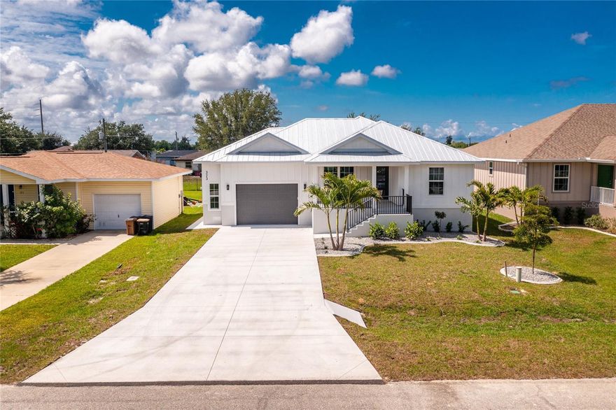 **NEW CONSTRUCTION** Impressive 3 Bedroom, 2 Bathroom home with attached 2 Car Garage located in the heart of Punta Gorda, 2 minutes from waterfront parks and the historic district. This light and bright home has beautiful design features throughout. There is an open and split bedroom floor plan with Great room, well appointed Kitchen, Laundry Room, front Porch, rear screened Porch-both porches have beautiful wood ceilings. The Great Room has a beautiful coffered ceiling and opens to the Kitchen. The Kitchen features wood cabinets, stone counters , breakfast bar, center island, dining area, walk in pantry, stainless sink and stainless appliances - Refrigerator, dishwasher, oven/range, oven hood, microwave. The Inside Laundry offers wood cabinets, stone counters, stainless sink, hookups for washer and dryer. The Master bedroom features a walk in closet Plus 2 built in closets and a private bathroom  with dual sinks, walk in shower, wood cabinets and stone counter. There are two additional generous sized bedrooms and the guest bathroom has wood cabinets, stone counter and tub/shower combo. Other features include: tile floors throughout, six ceiling fans, impact windows, metal roof, 2 car garage with shelving and epoxy floor. This home is minutes from historic downtown Punta Gorda shopping, dining, waterfront parks, boat ramps, art galleries, weekend farmer and artisan markets, Charlotte Harbor Event Center, Fishermen's Village and more. This is a beautiful new home in a great community