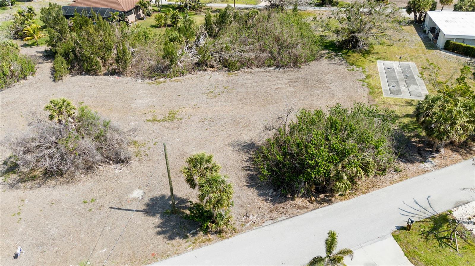 Nestled in the heart of historic Placida, this spacious 0.57-acre lot offers a rare opportunity to build your dream home in one of Southwest Florida’s most charming and timeless coastal communities. Located within a quiet, well-established neighborhood that borders the Intracoastal Waterway, the property combines natural beauty, historical character, and relaxed coastal living. Although the lot itself is not directly on the water, it enjoys close proximity to marinas, public boat ramps, and stunning Intracoastal views, placing world-class boating, fishing, and island-hopping adventures right at your fingertips. The neighborhood is known for its canopy of mature oaks, palms and iconic banyan trees, creating a lush, shaded setting that reflects the authentic spirit of Old Florida. Classic cottages, winding streets, and native landscaping make this a truly unique place to call home. With 0.57 acres of land, there's plenty of space to design a custom home, tropical garden, pool, or even a detached garage or guest suite. The property is located in a community with a voluntary HOA, offering the benefits of a well-kept neighborhood without the burden of mandatory fees. Just minutes away, you’ll find Boca Grande, Gasparilla Island, golf courses, beaches, nature preserves, and local restaurants—all contributing to the area’s laid-back, coastal lifestyle. This is a rare opportunity to own land in one of Placida’s most sought-after and storied neighborhoods. Build your legacy beneath the banyan trees, where history, nature, and the Intracoastal come together in perfect harmony.