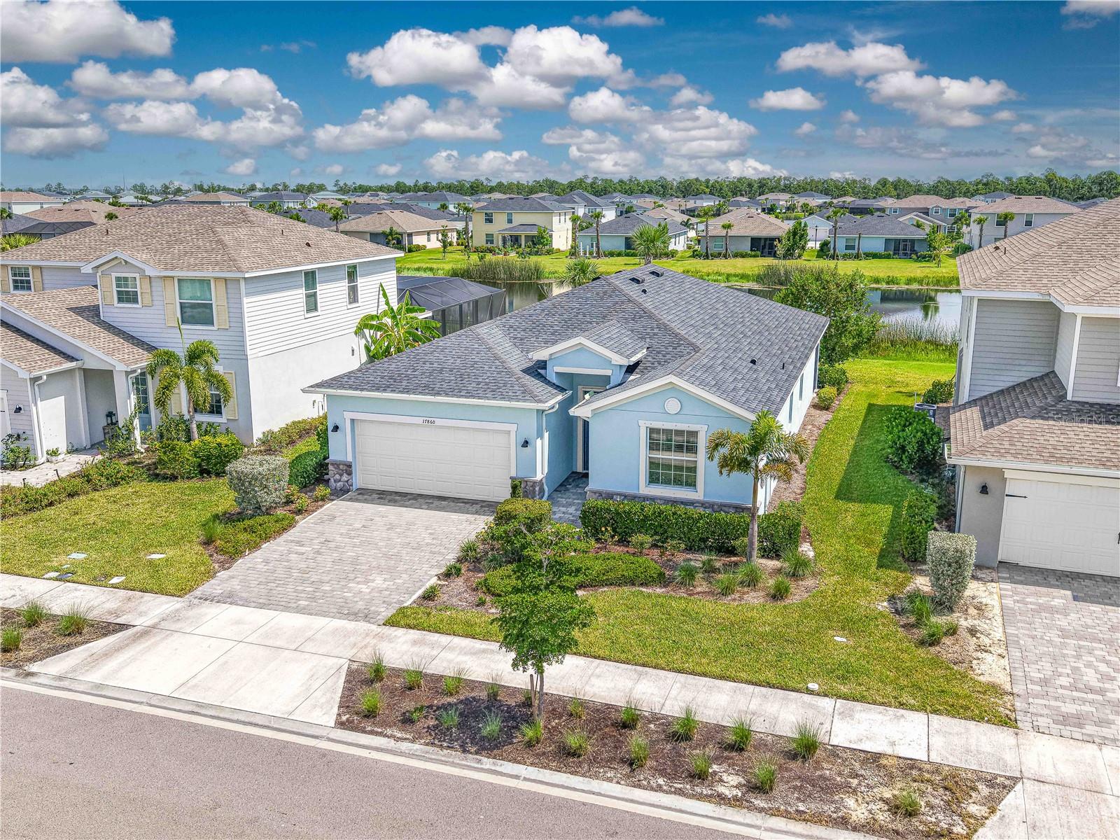 This stunning 4-bedroom, 3-bathroom home, built in 2022, offers light-filled, open-concept living with modern finishes throughout. Nestled on a waterfront lot with tranquil lake views, this home is designed for both relaxation and entertaining. Step inside to find tile flooring throughout the main living areas, plush carpet in the bedrooms, and a spacious great room that flows seamlessly into the kitchen and dining spaces. The gourmet kitchen features a large center island, perfect for gathering, sleek cabinetry, and plenty of counter space. The primary suite includes a luxurious oversized shower, walk-in closets, and serene water views. Three additional bedrooms offer flexibility for family, guests, or home office space. Enjoy Florida living year-round on the screened lanai, ideal for morning coffee or evening sunsets over the water. Additional highlights include a 2-car garage with durable epoxy flooring and plenty of storage space for tools, outdoor gear, or seasonal items. Inside, the home features neutral finishes throughout, offering a blank canvas ready for your personal style and design touches. Located in Trails Edge at Babcock Ranch, America's first solar-powered town, residents enjoy high-speed fiber internet, community parks, miles of nature trails, a vibrant town square, events year-round, resort-style pools, fitness centers, and top-rated Babcock Neighborhood Schools. Eco-friendly living meets modern convenience in this thriving, close-knit community.