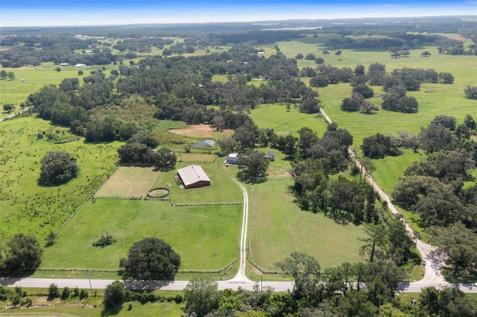 20-Acre Equestrian Estate with Dual Homes, 19-Stall Stable & Scenic Pond. Welcome to your private 20-acre retreat — a rare opportunity to own a fully equipped equestrian estate with two residences, premium horse facilities, and tranquil natural beauty. Two Full Residences - Each home offers 3 bedrooms, 2 bathrooms, flex room and attached garage — ideal for multi-generational living, guest accommodations, or rental income.
RV Pad with Full Hookups - Conveniently host guests, traveling trainers, or RV travelers with full utility access. Greenhouse & Storage Building - Grow your own produce year-round and keep equipment organized and protected.
Equestrian Facilities - 19-Stall Horse Stable with a bathroom and 2 utility rooms; 5 Pastures for grazing and rotation; Full-Sized Arena and Round Pen for training and events.
Private Pond - A serene water feature offering peaceful views and a touch of country charm.
Solar-Powered Gated Entrance - Enjoy enhanced privacy and security with eco-conscious operation.
This thoughtfully designed property is ideal for horse lovers, small-scale farming, or those seeking a self-sufficient lifestyle in a peaceful, rural setting - just bring your vision. All this, nestled on 20 private acres — ready to enjoy.
Schedule your private tour today and experience the possibilities.