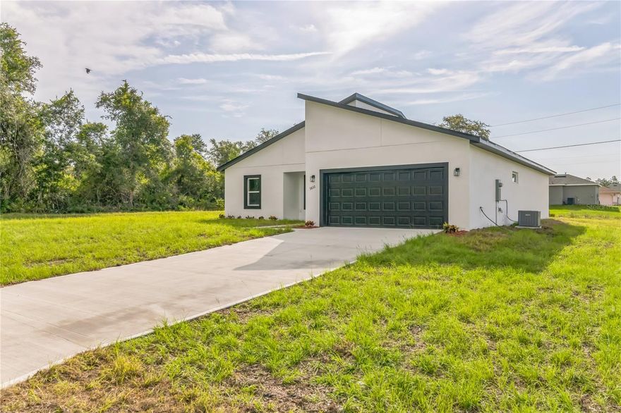 Welcome to 8151 SW 135th Loop, a brand-new single-family home located in the peaceful and fast-growing community of Marion Oaks, Ocala. This beautifully designed 1,833-square-foot residence (2,359 sq.ft. total construction) blends modern finishes, quality craftsmanship, and a functional layout—ideal for families or investors seeking a high-quality new construction in one of Central Florida’s most promising areas.

Step inside and you’ll find a spacious open-concept living area filled with natural light and finished with contemporary porcelain tile flooring in Calacatta Bianco tones, creating a bright and elegant atmosphere. The living and dining spaces flow seamlessly into a stylish kitchen featuring white shaker solid-wood cabinets, Luna Pearl granite countertops, soft-close drawers, and a full suite of Whirlpool stainless-steel appliances—including refrigerator, stove, microwave, and dishwasher. Designed for both everyday living and entertaining, this home offers a perfect balance of comfort and sophistication.

The primary suite features generous proportions, a large walk-in closet, and a bathroom with modern fixtures, dual undermount sinks, and a freestanding soaking tub paired with a brushed-nickel tub filler. Each additional bedroom provides ample space and light, making it ideal for family, guests, or a home office. All bathrooms include premium accessories and waterfall faucets, combining modern design with lasting durability. Energy-efficient LED recessed lighting throughout the home adds a refined touch while keeping maintenance low.

Every detail of this property reflects thoughtful planning and solid construction—from the concrete block structure to the roofing system, insulation, and interior finishes—ensuring long-term durability and low upkeep. The home includes a two-car garage, a paved driveway and walkway, complete landscaping, and a conventional septic system. It also features a modern HVAC system, plumbing, and electrical setup meeting Florida’s latest building standards, all under warranty.

Set on a quiet residential street, this home offers a relaxed lifestyle surrounded by the beauty and convenience of Ocala. Marion Oaks provides a family-friendly environment with easy access to main highways, schools, parks, shopping, and recreational amenities. With ongoing growth and development across Southwest Ocala, the area continues to attract attention for its strong value appreciation and long-term potential—making this property not only a comfortable home but also a sound investment opportunity.

Whether you’re looking for your primary residence, a seasonal getaway, or an income-generating asset, 8151 SW 135th Loop delivers the ideal combination of design, quality, and financial sense. Move into a brand-new home ready to welcome your next chapter in one of Florida’s most dynamic housing markets.
