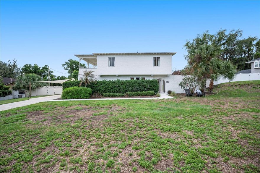 Discover timeless European charm in this beautifully designed Mediterranean-style home located in central Lakeland, complete with a resort-style pool and exceptional details throughout! From the moment you arrive, the inviting front courtyard and elegant wrought iron details set the tone for the character found throughout. Inside, soaring 12.5-foot vaulted ceilings with exposed beams and reclaimed wood accents create a warm, architectural statement. White wide-plank laminate flooring brings a light, European-inspired feel to the main living areas and primary suite, while engineered hardwood flooring adds richness to the additional bedrooms and staircase. This thoughtfully designed 4-bedroom, 2.5-bath tri-split floor plan offers both privacy and flexibility. A first-floor guest suite features a private entrance and ensuite, with convenient access to a half bath shared with the den. The remaining bedrooms, including the primary suite, are located on the third level. The spacious primary suite serves as a private retreat, complete with a covered balcony showcasing charming beams and serene views. Inside, enjoy a generous layout with a cozy window seat and an additional sitting area within the suite—perfect for relaxing. The chef’s kitchen is a true showpiece, featuring custom-built and painted cabinetry, leathered granite countertops, and a stunning Zia Spanish tile backsplash. High-end Italian appliances include a Bertazzoni induction range with convection oven and a Forno French door refrigerator, complemented by a wine fridge. Additional highlights include custom open shelving, a window bench nook with storage, and a floor-to-ceiling pantry for both beauty and function. Venture outside to your private backyard oasis on over half an acre, where a 20x40-foot pool with a depth of up to 9ft invites both relaxation and fun. The upper covered lanai features a built-in bar complete with a TV and fridge that convey with the home, and a newer lower wood deck provides even more space for entertaining. Major updates include a 2023 roof, 2021 AC system, and 2022 water heater, offering peace of mind for years to come. The garage is configured as a one-car space, with the second space converted into a spacious laundry area. This one-of-a-kind Lakeland home perfectly blends Mediterranean elegance, modern upgrades, and exceptional indoor-outdoor living!