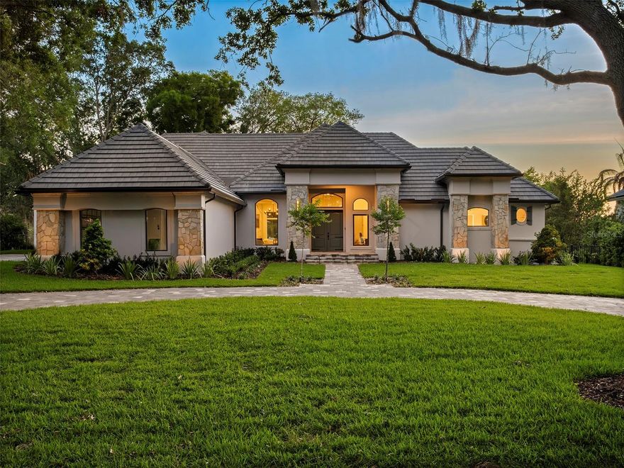 Set along Isleworth’s signature 12th fairway, this fully reimagined estate captures the essence of refined golf course living within the renowned Isleworth Golf & Country Club—recognized among the finest private club communities in the world. Encompassing more than 4,300 square feet, the single-story residence has been completely transformed inside and out. Thoughtfully redesigned interiors showcase all-new flooring throughout, beautifully renovated bedrooms and baths, and a striking glass-enclosed wine tower serving as a true centerpiece that is both functional and an unforgettable conversation element anchoring the main living spaces. Every detail throughout the home has been elevated, from designer lighting installations that bring character and sophistication to each room, to the seamless flow of living and entertaining spaces. The kitchen is a true showpiece, featuring all-new appliances—including a striking black range with matching hood, refrigerator, and microwave—all accented with elegant gold detailing for a bold, designer-forward statement. Custom cabinetry is paired with exquisite countertops, highlighted by a dramatic waterfall-edge island that anchors the space and seamlessly blends everyday functionality with elevated, modern style.The outdoor living area features a reimagined pool and all-new pool deck creating a resort-style setting, perfectly positioned to take in breathtaking sunsets over the golf course and water. The half-acre homesite has been thoughtfully cleared and fenced to maximize both privacy and panoramic views, offering an exceptional backdrop for everyday living and entertaining alike. Framed by the fairways, the residence captures views of Lake Brenda - also known as Hourglass Pond - a small, privately maintained 10-acre water body that serves as a peaceful and picturesque part of the community setting. Additional features include a home office, in-home laundry room, and a three-car garage. Residents of Isleworth enjoy an unparalleled lifestyle surrounded by the Butler Chain of Lakes, with access to world-class golf, dining, and amenities, all just moments from Central Florida’s premier shopping, dining, and entertainment destinations.