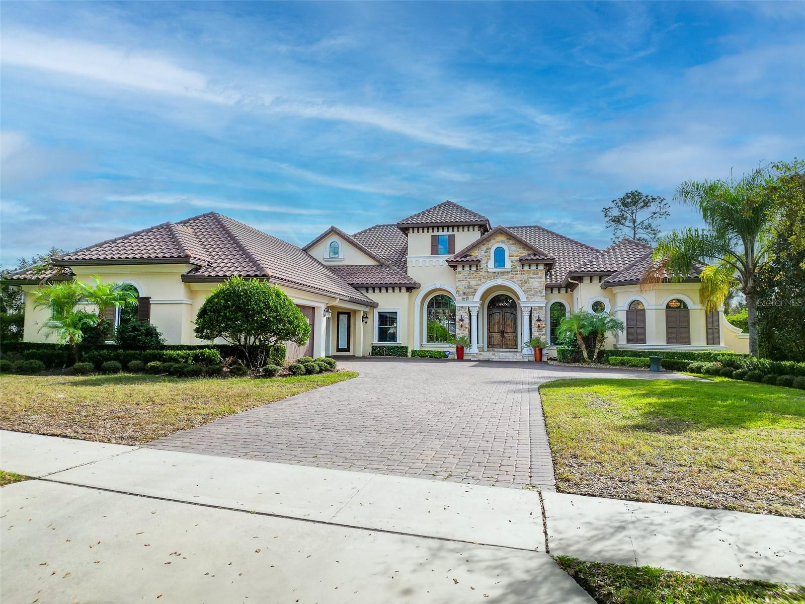Discover modern luxury in this custom-built executive home located in Alaqua Lakes, completed in 2015. Crafted by renowned builder Dave Brewer, this residence effortlessly combines sophistication with functionality.
The thoughtfully designed one-story floor plan features a seamless flow, with two bedroom suites at the front, an oversized study adjacent to the Master Retreat, and two additional bedrooms in the middle. The rear of the home boasts an expansive bonus room with a full bar, offering versatile living space.
No detail has been overlooked in the design and finishes, from the travertine floors and 10-foot sliders to the chef-quality Thermador Professional series appliances in the kitchen. Notably, this home is equipped with a natural gas Wi-Fi controlled generator, providing full-house coverage for added peace of mind.
Entertain with ease in the open and airy family room, where pocket sliders disappear into the walls, seamlessly merging indoor and outdoor spaces. The outdoor area is a haven for relaxation, featuring a salt pool, raised hot tub with a waterfall edge, a summer kitchen with an Artisan vented stainless grill, and a natural gas fireplace. Enjoy panoramic views of the golf course from the fenced rear yard.
This home is as functional as it is elegant, with a four-car garage providing ample space and convenience. Inside, the Master Retreat exudes sophistication with wood floors, a spacious double closet, and a stunning bathroom. The bonus room extends the entertainment options, complete with an extended bar, two kegs, a beverage refrigerator, and a Bosch stainless dishwasher.
In summary, this meticulously designed home seamlessly blends upscale living with practical amenities, offering a rare combination of elegance and functionality in a prime Alaqua Lakes location.