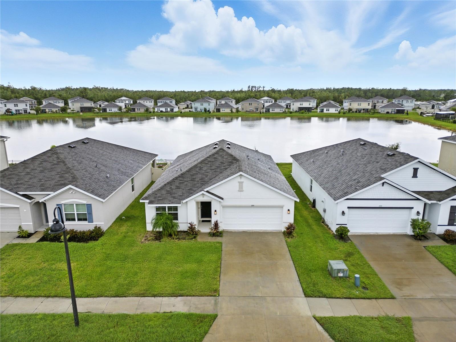 What an amazing WATERFRONT OPPORTUNITY! This picture perfect, nearly new home on a quiet street in The Preserve! The Aria floor plan features an open concept making the kitchen the heart of the home! Oversized family room with shiplap accents, light and bright dining room along with the kitchen and owner's retreat all enjoying these WATERFRONT VIEWS! Ample windows allow natural light to flood the space that has been lovingly upgraded! the home features 5 1/4" baseboards, crisp charcoal cabinets, New Flooring, granite counters, farmhouse sink, upgraded faucet and new chrome hardware continue to add value to this well priced home. Owner's retreat is spacious with a decorative accent wall, walk-in closet, double sinks and nicely sized shower. Guest rooms are on the opposite side of the home and share a convenient guest bath. Large breakfast bar island is a great gathering spot for entertaining or quick breakfast, you name it! Ready to explore your waterfront oasis? The expansive paver decking is phenomenal for entertaining, big family BBQ's or simply enjoying the morning sunrise over the pond with coffee! It shares space under roof and under the stars! This wonderful home also offers a water softener system, keyless entry system, IQ System, Ring system with cameras, hurricane shutters and so much more!