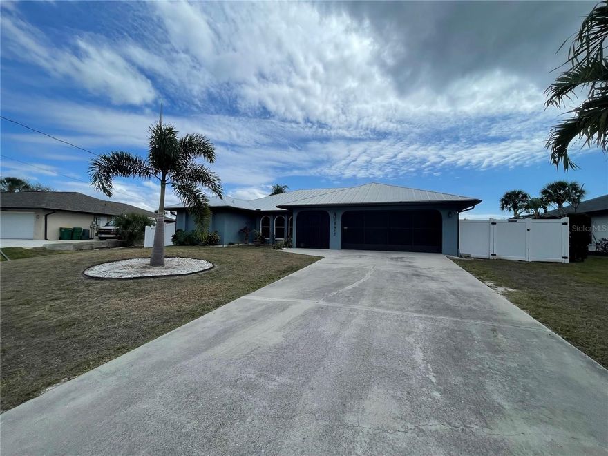 This house has it all! Beautiful 3 bedroom, 2 bath home on canal with quick access to Charlotte Harbor. Updates include: 2020- New metal roof. 2022- Exterior professionally painted. 2023- Hurricane windows installed, pool resurfaced and bench seating added, iron fencing installed and garage floor epoxied. 2024- New A/C unit, new pool cage with unobstructed picture window as well as new gutters, soffits and garage/entryway screening. This home additionally boasts a boat lift, a floating dock for easy kayak launching, and fish cleaning station right at the dock. An open floor plan with 3 skylights allow for plenty of natural light. Some furnishings may be negotiable, making this home perfect as a rental or AirBnB. Showings by appointment to pre-approved buyers. Sliding glass doors open all the way into the wall for large opening into lanai.