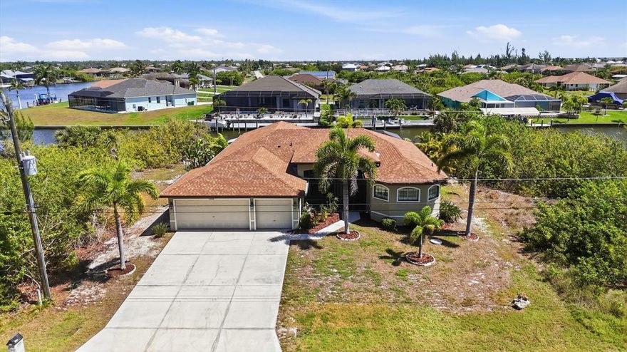 WELCOME TO YOUR FLORIDA WATERFRONT RETREAT! Perfectly positioned on a scenic canal and ideally located halfway between Sarasota and Fort Myers, this beautifully designed 3-bedroom, 2-bath residence offers over 2,200 square feet of thoughtfully crafted living space with the perfect balance of comfort, functionality, and the Florida lifestyle you’ve been dreaming of. From the moment you step inside, you’ll be welcomed by an inviting floor plan filled with natural light and designed for both everyday living and effortless entertaining. The spacious living areas flow seamlessly into the kitchen and dining spaces, creating the ideal setting for gathering with family and friends. In addition to the dedicated office, this home features both flex and bonus spaces, offering endless opportunities for a game room, hobby space, fitness area, media room, or additional areas for creating lasting memories with those you love most. The spacious primary suite serves as a private retreat, complete with walk-in closets and a beautifully appointed ensuite bathroom featuring dual sinks and an impressive walk-through shower designed with both comfort and style in mind. Step outside and embrace true Florida waterfront living. The expansive screened lanai overlooks the heated pool and tranquil canal views, creating the perfect backdrop for relaxing mornings or sunset evenings. The new pool pump adds peace of mind for the next owner. Boating enthusiasts will appreciate the private dock and 10,000 lb. boat lift, providing quick and convenient access to the water right from your backyard. Additional highlights include a NEW ROOF installed in 2022, NEW AC and WATER HEATER both replaced in 2025, a desirable 3-car garage, and an irrigation system designed to help maintain the lush Florida landscaping with ease. Ideally located close to pristine Gulf beaches, shopping, dining, championship golf courses, and world-class fishing opportunities, this exceptional property offers the perfect blend of relaxation, recreation, and everyday convenience. Whether you are searching for a year-round residence or your own private slice of paradise, this waterfront home delivers the lifestyle, space, and location to truly enjoy the very best of Southwest Florida living. Paradise Awaits you.
