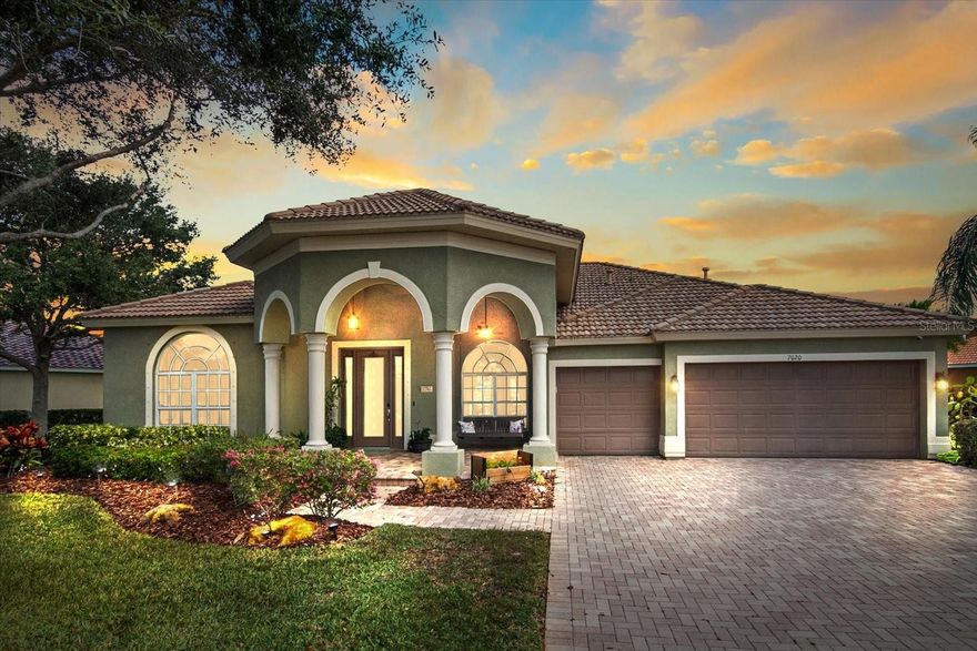 Discover your sanctuary in the exclusive gated community of River Place, where this meticulously maintained Spanish Mediterranean home offers 2,958 square feet of thoughtfully designed living space. This impressive split-plan residence features four bedrooms and three bathrooms, complemented by a three-car garage and an array of elegant entertaining spaces.

The home welcomes guests through a striking domed four-column porch entry, providing access to formal living and dining rooms, a comfortable den, and an expansive open kitchen seamlessly connected to the family room. Crown molding graces the main living areas, adding architectural sophistication throughout.

The primary bedroom suite serves as a private retreat with laminated wood floors, a custom-designed walk-in closet, dual sinks, and a relaxing garden tub. This luxurious space enjoys its own dedicated gas air conditioning unit and offers serene lake views alongside the adjoining den.

The outdoor living experience truly shines with a paved lanai featuring three automatic screens, and breathtaking lake vistas. The oversized pie-shaped lot includes a convenient horseshoe driveway, while the community amenities of pool and clubhouse are nearby.

Location advantages include proximity to major highways, the University Town Center Mall, diverse dining options, shopping centers, and healthcare facilities. Nature enthusiasts will appreciate nearby Jiggs Landing Nature Park, offering reservoir access, boat rentals, fishing opportunities, playground facilities, and picnic areas.

Recent updates include a new toilet installation, back door replacement, and dishwasher upgrade. The property is offered as-is, with new buyers responsible for a one-time capital contribution of $600.