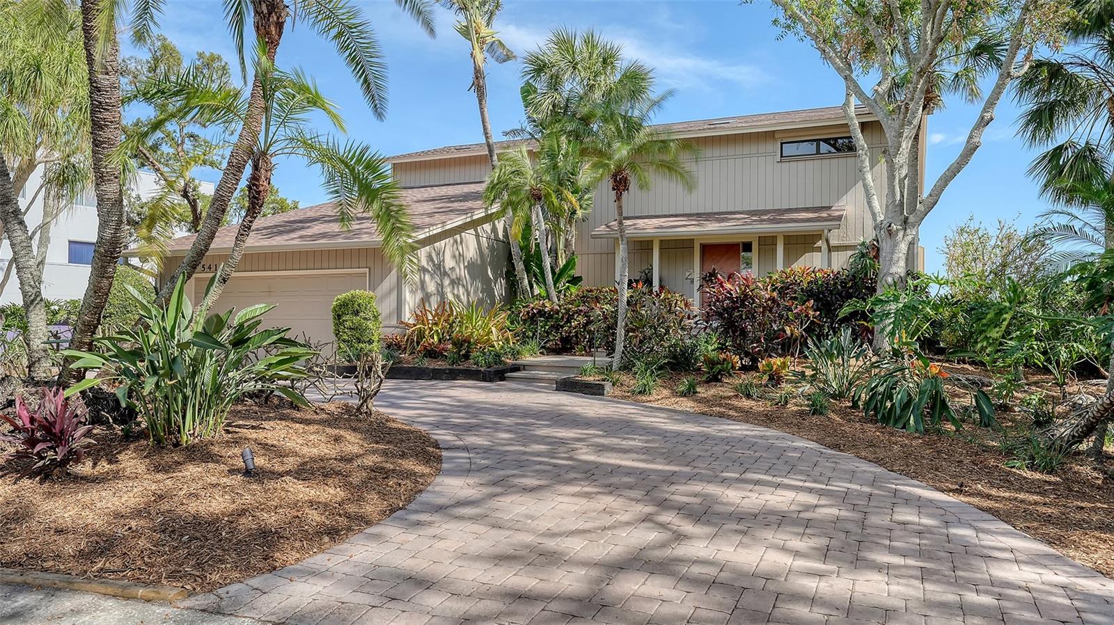 Set on 110+ feet of waterfront with an impressive 11’ elevation, this exceptional 4BR/3BA, 2-story home is in beautiful condition and is perfectly located in the highly sought-after Siesta Cove neighborhood. Offering peace of mind and luxury living directly on the Intracoastal Waterway in a quiet no-wake zone, the setting is idyllic, with abundant wildlife and frequent dolphin sightings providing a daily waterfront spectacle. Upon entering, you are greeted with a grand, lofty foyer, enhancing the sense of space, with wood and travertine marble floors complementing walls of sliders that showcase breathtaking 180-degree water views and open out to the expansive outdoor entertainment area. The backyard is a true oasis, boasting a large, elevated pool, a spacious pool deck and a recently inspected seawall ready for a potential deep-water boat dock and lift—ideal for any water enthusiast. The kitchen is beautifully appointed with stone countertops, ample storage, and a built-in desk. Upstairs, the primary suite is a private sanctuary, with sliders opening to a second-story terrace that overlooks the Intracoastal Waterway with views of downtown Sarasota, custom built-in furniture and a travertine marble en-suite bath featuring dual vanities, a spa tub, and a glass walk-in shower. The additional oversized guest bedrooms are equally inviting, offering terrace access, plenty of privacy and water views. Recent updates include a new roof (2020), impact glass skylights, a hurricane-impact garage door and storm shutters. Less than one mile from the world-famous Siesta Beach, #1 in the country and moments from the vibrant shopping and dining of Siesta Key Village. The Sarasota County public school district is “A” rated! This home epitomizes refined waterfront living.