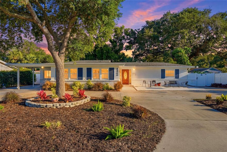 6900 10th Avenue N places you in one of St. Petersburg’s most convenient everyday locations...where grabbing dinner, heading to the Gulf beaches, running errands, or spending the evening downtown all feels effortlessly close to home. In a city where lifestyle and accessibility matter, the Crossroads area continues to stand out for buyers who want space, comfort, and central convenience without compromise.

Inside, this 3 bedroom, 2 bathroom residence offers more than 2,000 square feet of thoughtfully designed living space with an open floorplan and a highly desirable split-bedroom layout that creates both connection and privacy. The flow feels natural and welcoming, with expansive living areas that provide flexibility for everything from casual evenings at home to larger gatherings with friends and family.

The interior carries a comfortable sense of scale throughout, complemented by numerous practical upgrades including all new impact glass windows, a newer roof, newer HVAC system, and newer water heater; improvements that add long-term value while supporting easy everyday living.

The screened lanai creates a relaxing extension of the home, centered around a private hot tub/spa that brings a quiet resort-style atmosphere to the property. Beyond the French doors, the backyard opens into a surprisingly generous outdoor setting with lush lawn space, patio areas, pergola shade structures, and multiple places to unwind, entertain, garden, or simply enjoy Florida’s year-round outdoor lifestyle. Two storage sheds provide additional flexibility for hobbies, tools, recreational equipment, or workspace needs.

Additional highlights include a large interior laundry room, circular driveway, covered carport, and exceptional parking options.

For buyers seeking interior space, outdoor livability, meaningful updates, and one of St. Petersburg’s most practical central locations, this home delivers a compelling balance of comfort, functionality, and lifestyle.