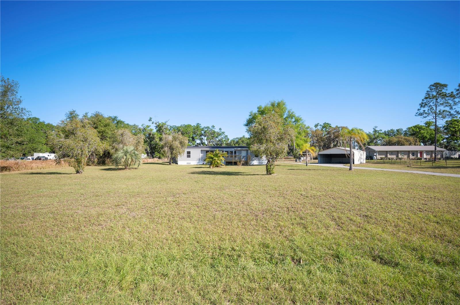 Tranquil 2.5-Acre Oasis – Remodeled 3BR/2BA Mobile Home with New Updates & Endless Possibilities!
Escape to your own slice of country paradise! This beautifully remodeled 3-bedroom, 2-bathroom mobile home sits on a peaceful 2.5-acre lot, offering privacy, space, and unlimited potential.
Step inside to discover a fresh, modern feel with new flooring, fresh paint, updated doors, and a charming brick fireplace that adds warmth to the spacious great room. The country-style kitchen has been thoughtfully updated with brand-new appliances, blending rustic charm with modern convenience.
Major updates include a new roof, new windows, new siding, new water heater, and updated plumbing—ensuring lasting comfort and efficiency.
Outside, enjoy the huge 24x24 two-car carport and expansive open yard, perfect for your toys, farm animals, or even a future guest house! With agricultural zoning, you have the flexibility to create your dream homestead or simply savor the wide-open space.
Don't miss this incredible opportunity—a peaceful retreat with room to grow, all at a fantastic price!