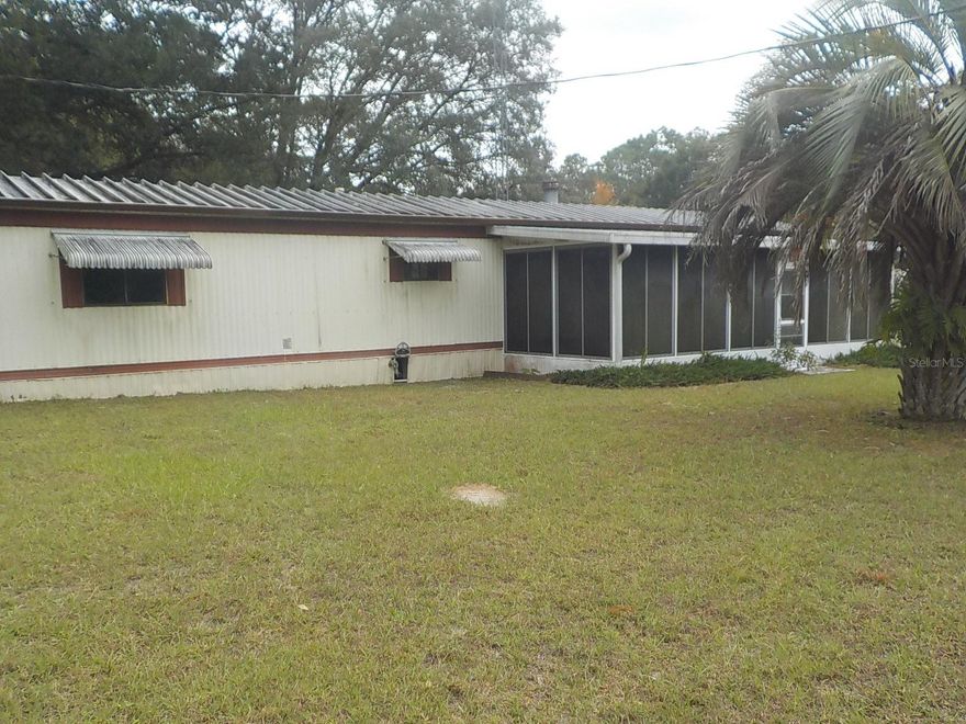 Wow this home as a large front and back porch to enjoy!  Fenced back yard for the fur babies a shed and a workshop!!  Combine that with a split plan 2 bedroom 2 bath home with a fireplace and a super nice kitchen.  The laundry room is in the kitchen for convenience.  Close to Dunnellon, Grocery store just a few minutes down the road.