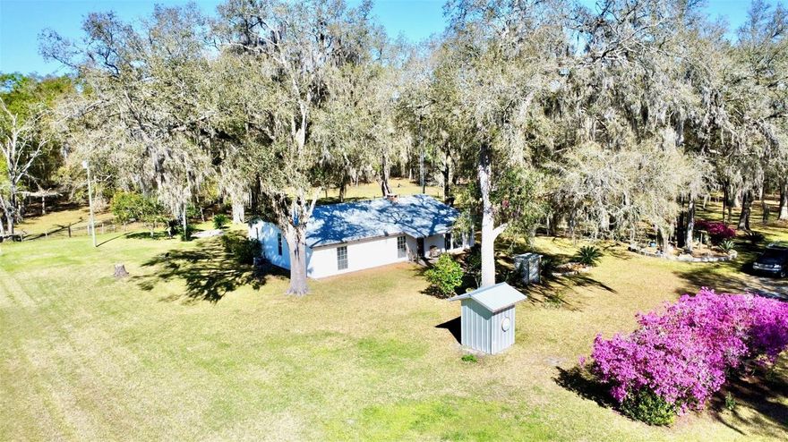 Check out this beautiful almost 12-acre property with a site-built home, workshop & a stocked pond in North Alachua County, Florida just north of Lacrosse that is for sale! As you come down the lane there are green pastures on either side of you that could be great farmland or pasture for livestock. The property is fully fenced and has a gate. Once you are up the lane, there is a metal roofed 4 bedroom/2 bathroom home that has been well cared for with a front sitting porch and an enclosed back porch with a cooktop, cabinets for storage, a stand-up freezer & laundry facilities. The home has a split-level interior floorplan, LVP flooring, a separate dining room and an owner's suite with a bay window on the front of the house with an ensuite bathroom and 2 walk in closets. Outside is a nice sized workshop with electricity & water, 3 bays, a container for storage & a side carport for parking. This is a haven for an outdoorsman, with a mixture of hardwoods and a couple of deer blinds to scout out wildlife AND don't miss the stocked pond with the "She Shed" that has water & electricity with a small dock for fishing! There is also a concrete slab that could be finished for another workshop, small barn or in-law suite. This property has many possibilities and is a haven for those who like to get outside! About 30 minutes to Gainesville, 20 minutes to Starke or 40 minutes to Lake City. Call to schedule your private showing of this special rural North Florida homestead and property!