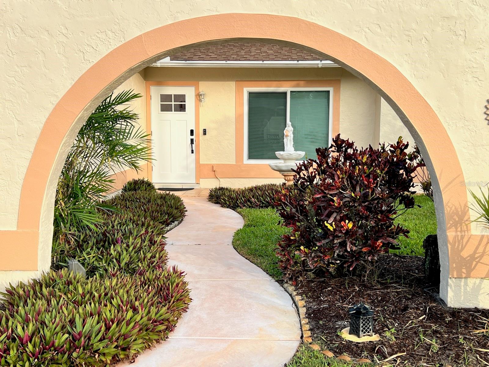 HAS BEEN LEASED THROUGH JUNE, 2025. Indulge in the charm of this furnished 3-bedroom, 2-bath home nestled in Village Green. Immerse yourself in the luxury of tile flooring that gracefully extends throughout the space, leading you to a spacious screened patio. From this private oasis, bask in the serene views of a meticulously manicured lawn and the tranquil melodies of a water fountain. The master bedroom is a retreat in itself, featuring a queen-size bed, a generous walk-in closet, and a wall-mounted TV. The ensuite bathroom boasts a refreshing shower for your convenience. The guest bedroom is comfortably appointed with a queen bed and a TV, while the second guest bedroom doubles as a versatile workspace with a day bed and desk. The guest bath is thoughtfully designed with a tub/shower combination. For added convenience, a washer/dryer duo is discreetly tucked away in the garage. This residence not only offers a comfortable and stylish living space but also provides easy access to shopping, restaurants, and the pristine beaches that make coastal living a dream. Don't miss the chance to make this home yours—schedule a viewing today! If the home is leased 6 months or longer, Tenant is responsible for all water and electricity. Lawn care and WiFi will remain included.