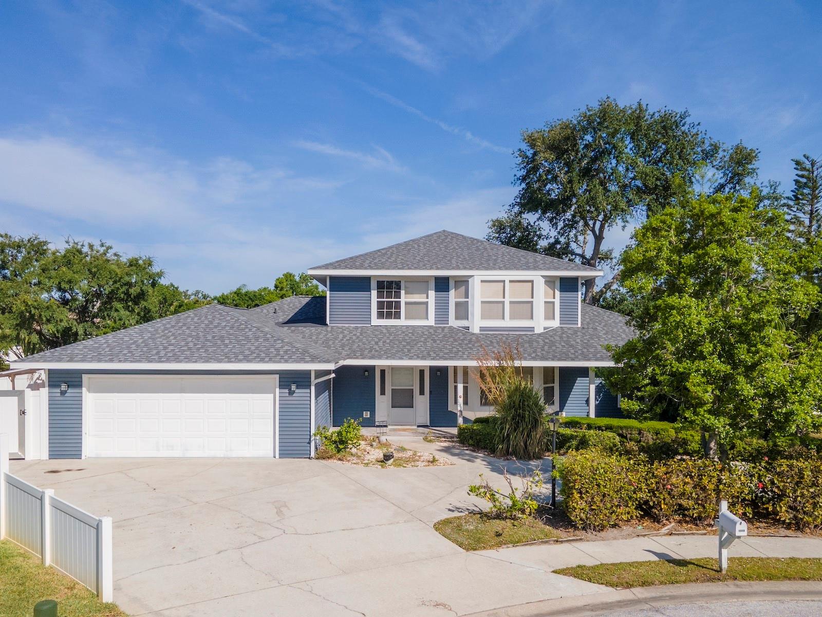 This executive home in Northwest Bradenton's Fiddlers Green offers 5 generous bedrooms in a 3-way split and 3 full bathrooms in a 2-story home with nearly 3000 sq. ft of living space. Enter from the covered porch into a foyer with an elevator to the 2nd floor. There is a separate living room with a charming fireplace and a formal dining room large enough to host a large dinner party. The chef's kitchen offers ample counter space, lots of storage, a new stainless steel range and a new stainless steel refrigerator, plus a breakfast bar. There is a cozy breakfast nook with large windows between the kitchen and the living room. The elevator serves the upstairs primary bedroom, which has the potential to be a complete in-law suite with its galley kitchen, laundry hook-ups, and the other upstairs bedroom could be a sitting room for the suite. With a small balcony overlooking a tranquil pond, the upstairs guest bedroom/sitting room could be a lovely retreat at the end of the day. The en suite primary bathroom is spacious and recently renovated with a walk-in shower, privacy toilet, and walk-in closet. Downstairs, there are two bedrooms with a Jack and Jill bath in a short hall off the kitchen. A third downstairs bedroom, off the living room, has an en suite bathroom, so it could be a downstairs primary bedroom. There is an inside laundry room for a washer, dryer, and sink, separating the garage from the main living areas. The 2-car garage is deep enough for a workshop. You will enjoy the large, covered, and screened lanai with a nice view of a pond that attracts lots of birds. With 200 square feet, there is ample space on the lanai for grilling your favorite meal, watching your favorite sports game, and casual outdoor living. Lush landscaping surrounds the home, enhancing its appeal and privacy. The property has never flooded or suffered wind damage. This prime location is within biking distance to Robinson Preserve and Palma Sola Botanical Gardens, which offers 682 acres of nature preserve with scenic outlooks, hiking trails, kayak launches, and picnic areas. It is just a short drive to DeSoto Park, the sugary sands of Anna Maria Island, and Coquina Beach. Downtown Bradenton shopping, fine and casual dining, and entertainment are 15 minutes away. Schedule an appointment today to see this beautiful home.